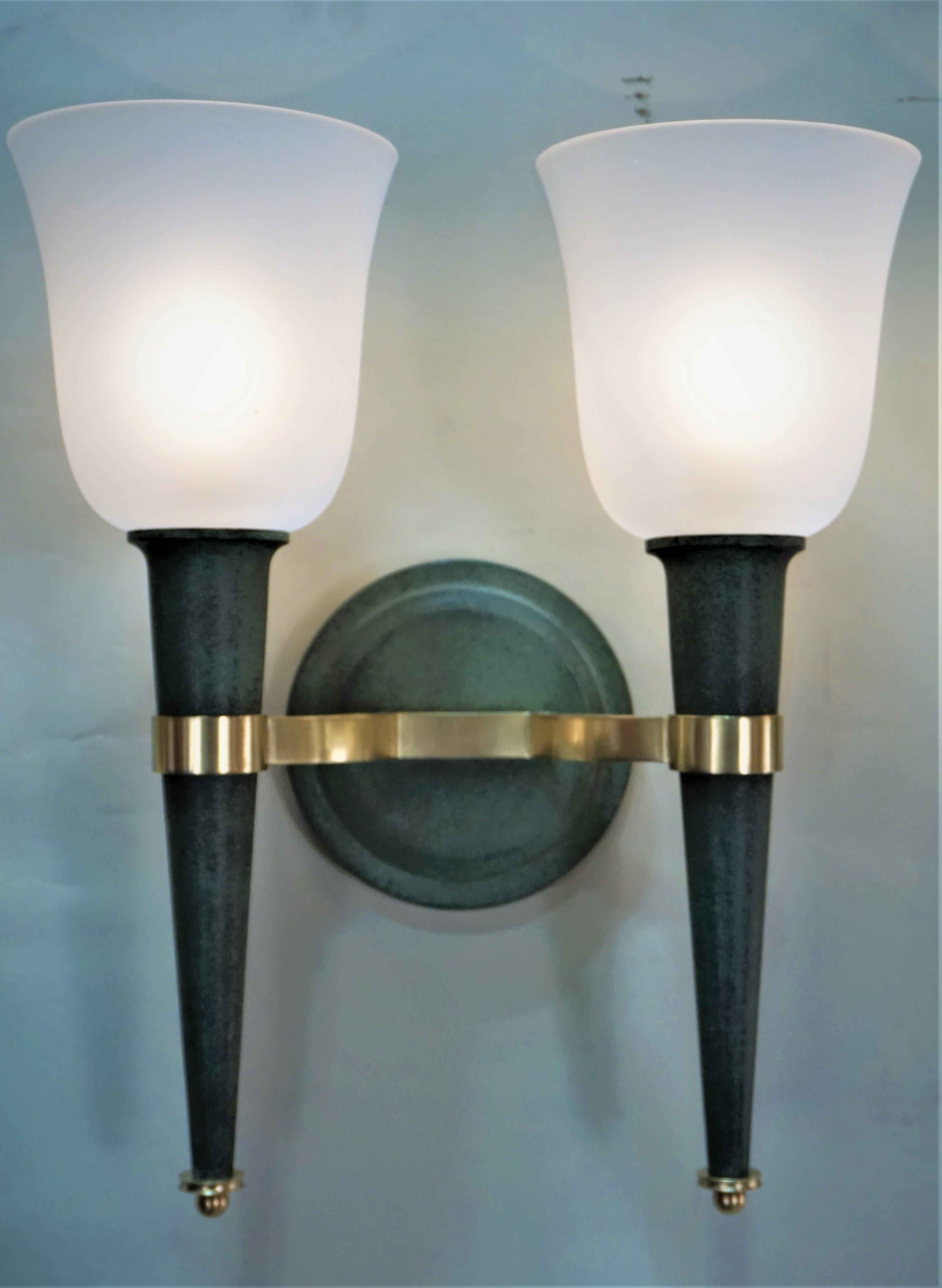 Combination of verdi green/black patina with satin finish bronze double arm torchere wall sconces.