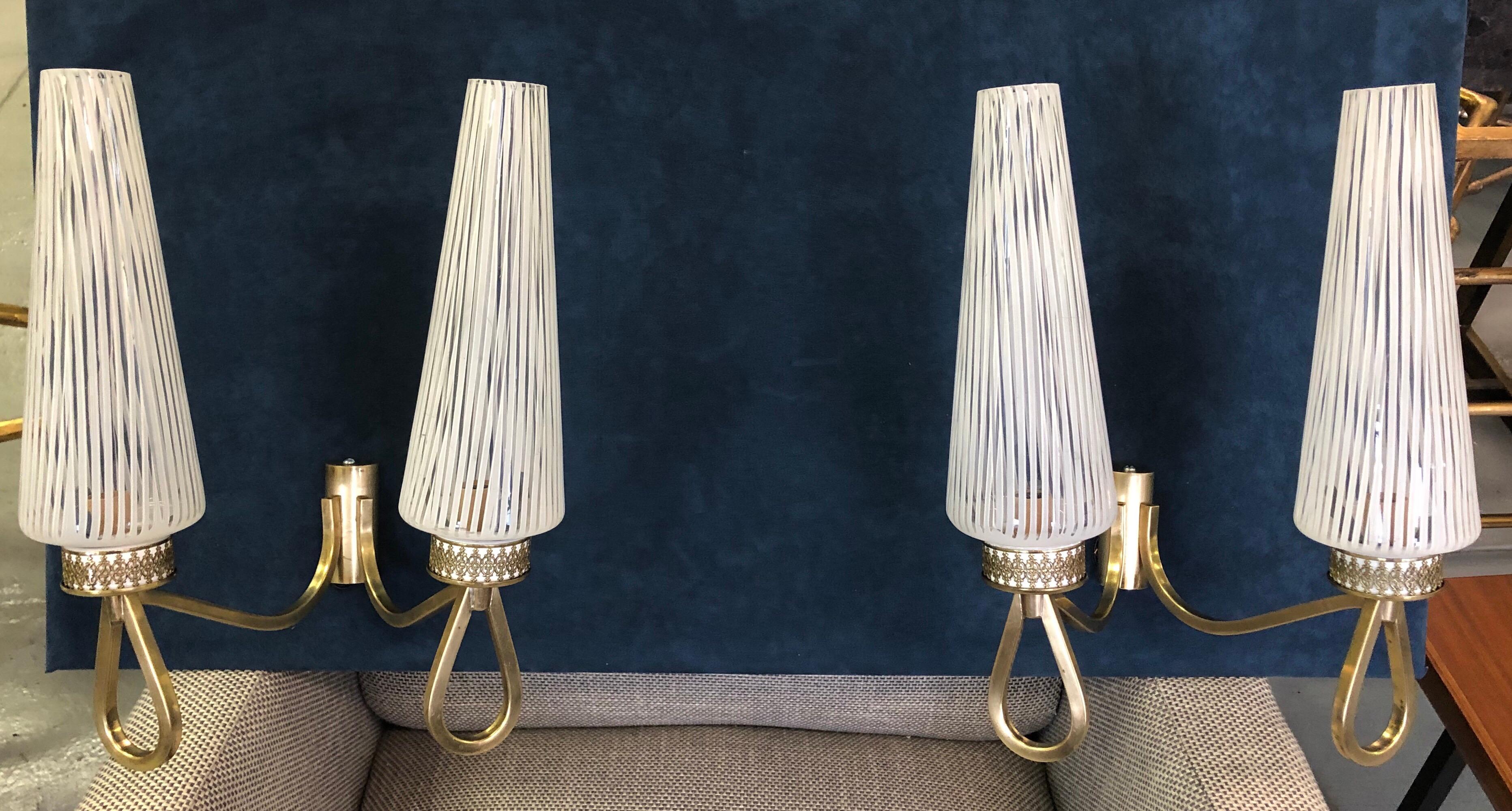 Elegant pair of Italian Mid-Century Modern neoclassical double arm Murano sconces with glass by Venini 

The structure for the sconces is in solid brass; the shades are hand blown 'lattimo' glass by Venini in a conical form tapering toward the