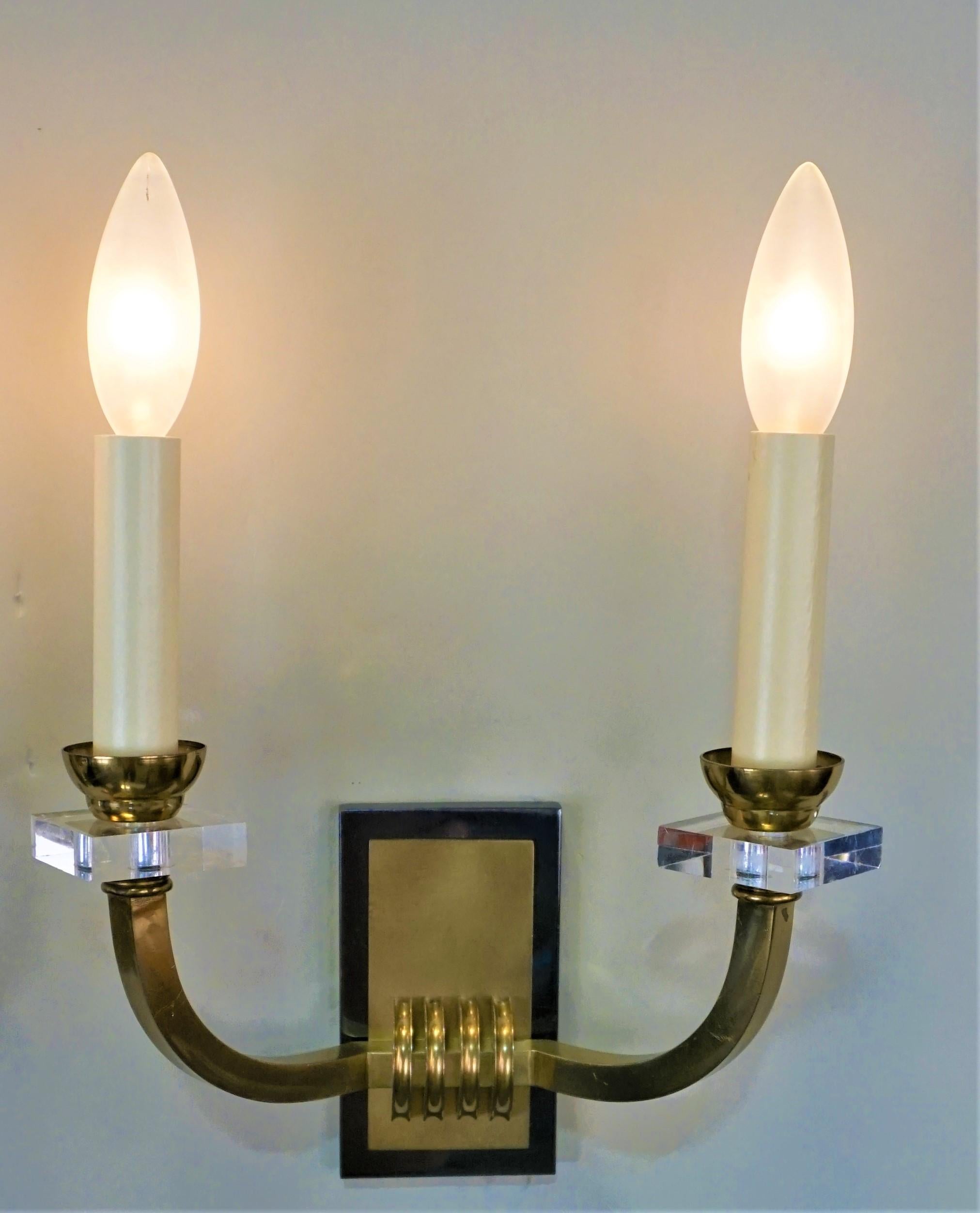Simple but elegant pair of double arm bronze and oxidized wall sconces by world renowned modernist designer Jacques Adnet.
Measurement is without lampshade.
The backplate is 2.75