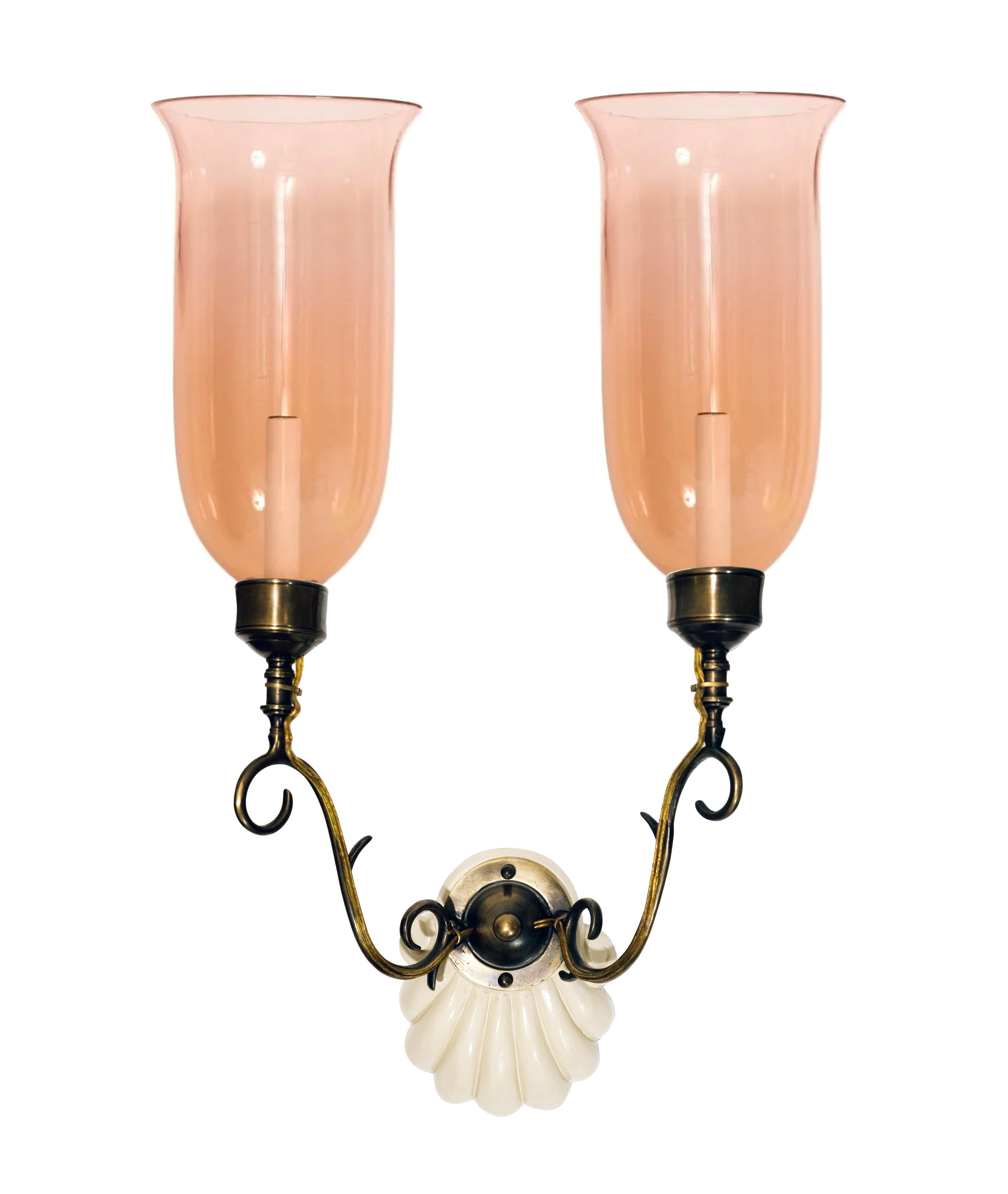 A pair of hand-carved mahogany scallop sconces by David Duncan Studio. The backplates with a hand-painted artisan finish with a base of Benjamin Moore Berber White. The blown pink glass shades with hand-flared edges secured with patinated cast brass