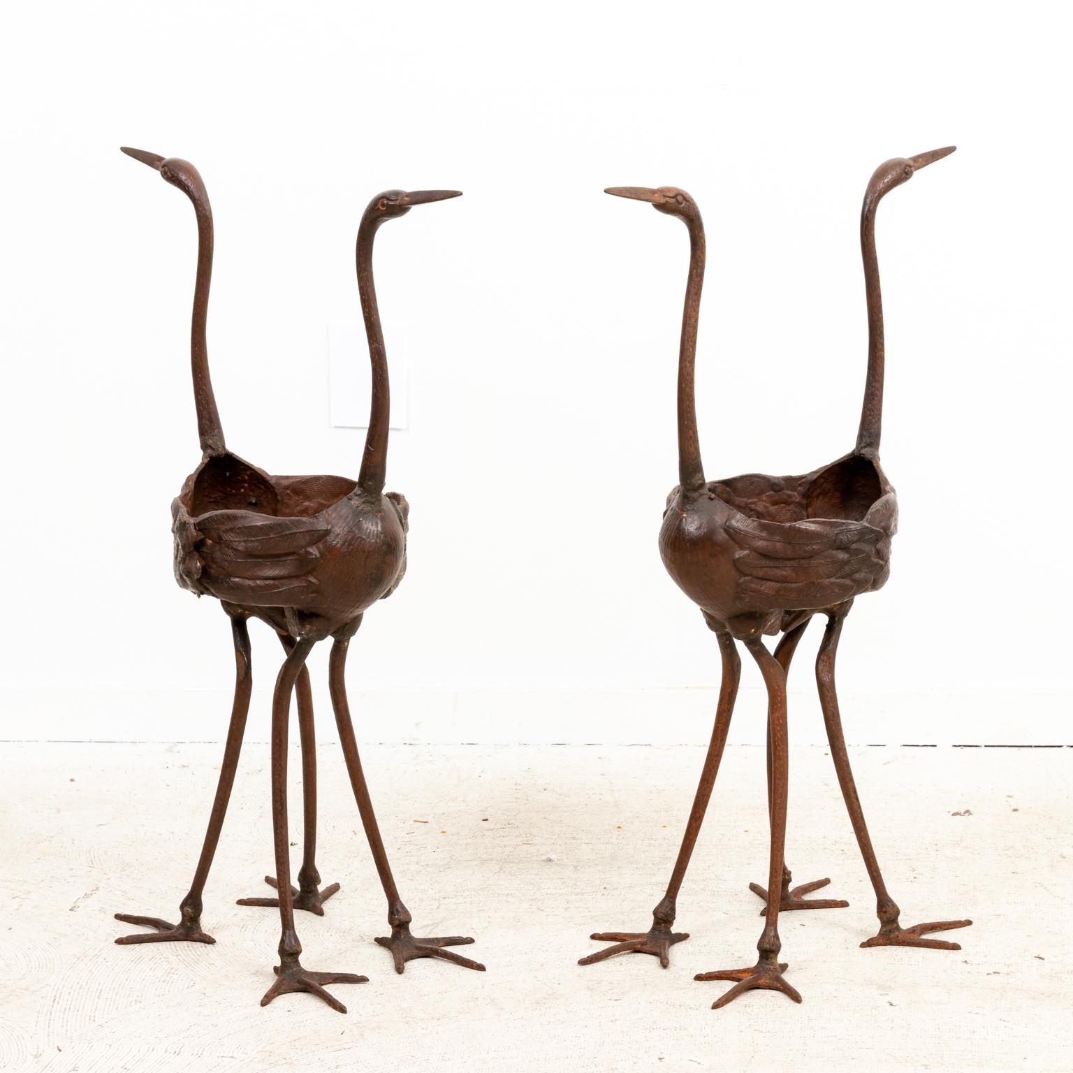 Circa 2012 contemporary pair of Iron double crane garden jardinières for use as planters. Please note of wear consistent with age.