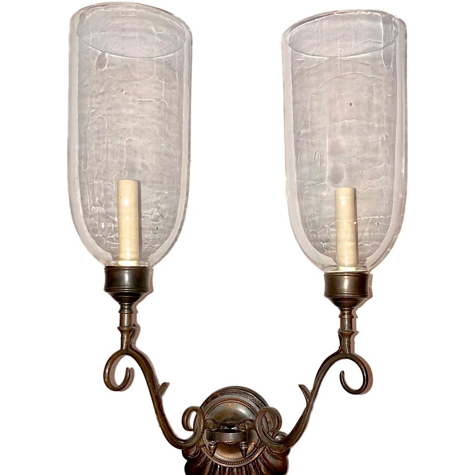 Pair of Anglo-Indian double light sconces with wooden backplate and patinated bronze finish.

Measurements:
Height 22?
Width 14?
Depth 12?.