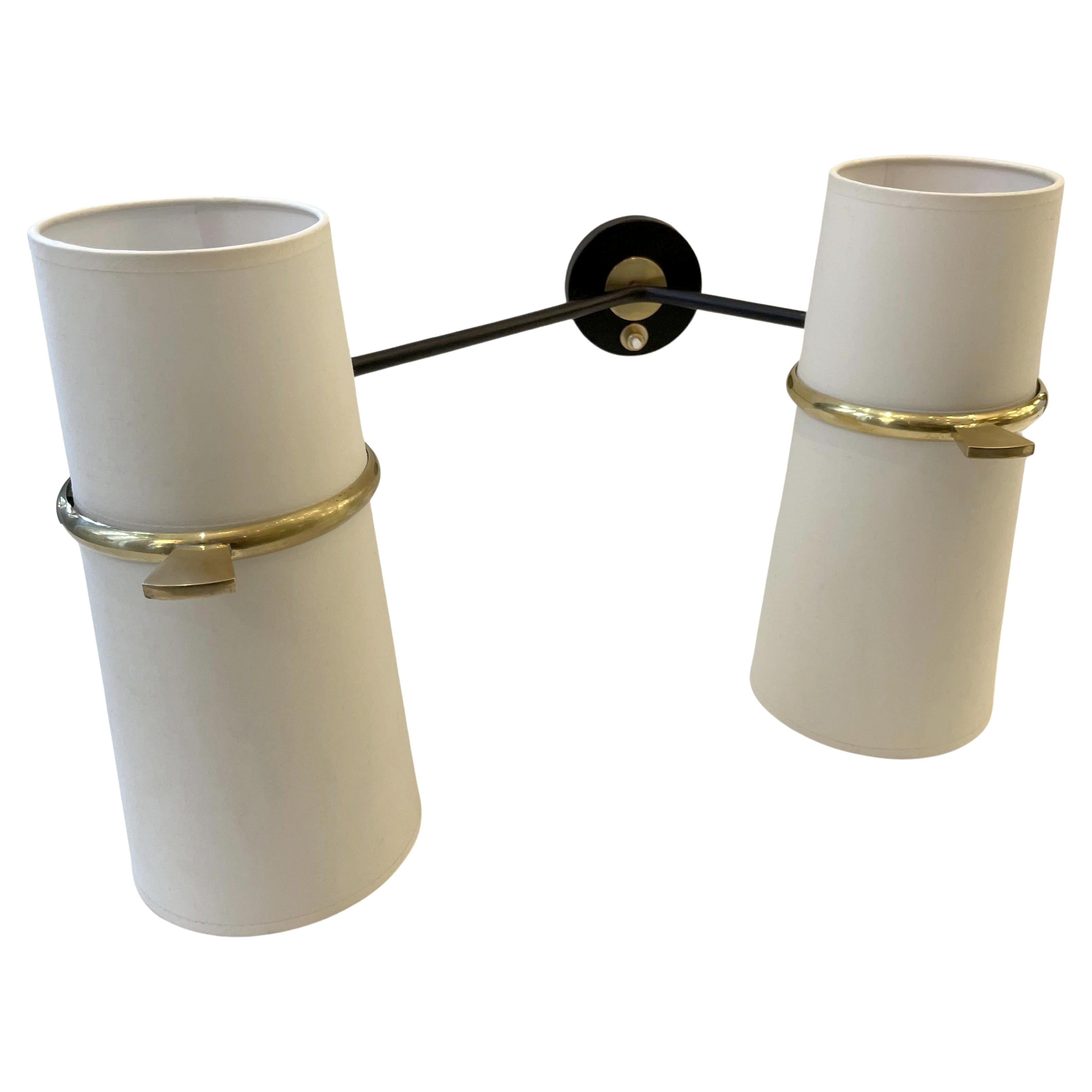 Rare pair of double-light adjustable sconces from Maison Lunel, France circa 1950.
Two arms fitted with ball joints, each supporting a double shade in off-white cotton and two electric bulbs.
Black lacquered wrought iron and polished