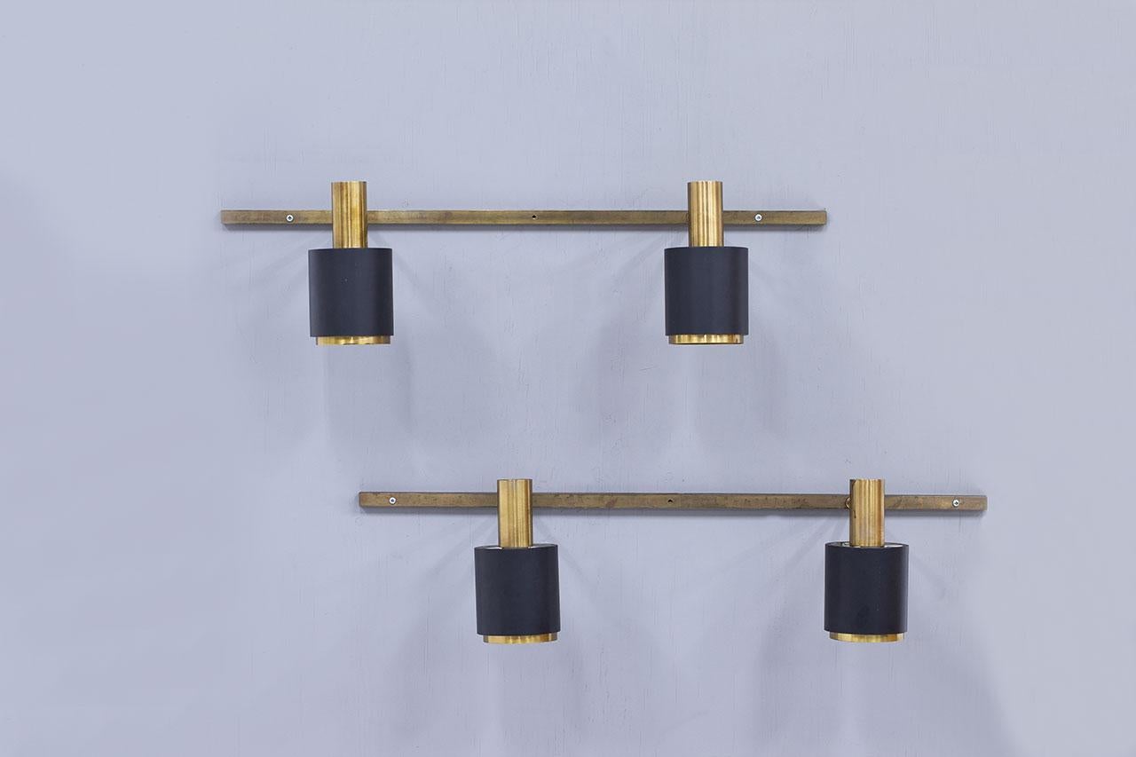 Pair of wall lamps with double spots most likely manufactured in Denmark
during the late 1960s / 1970s.  Made from brass with lacquered metal shades.