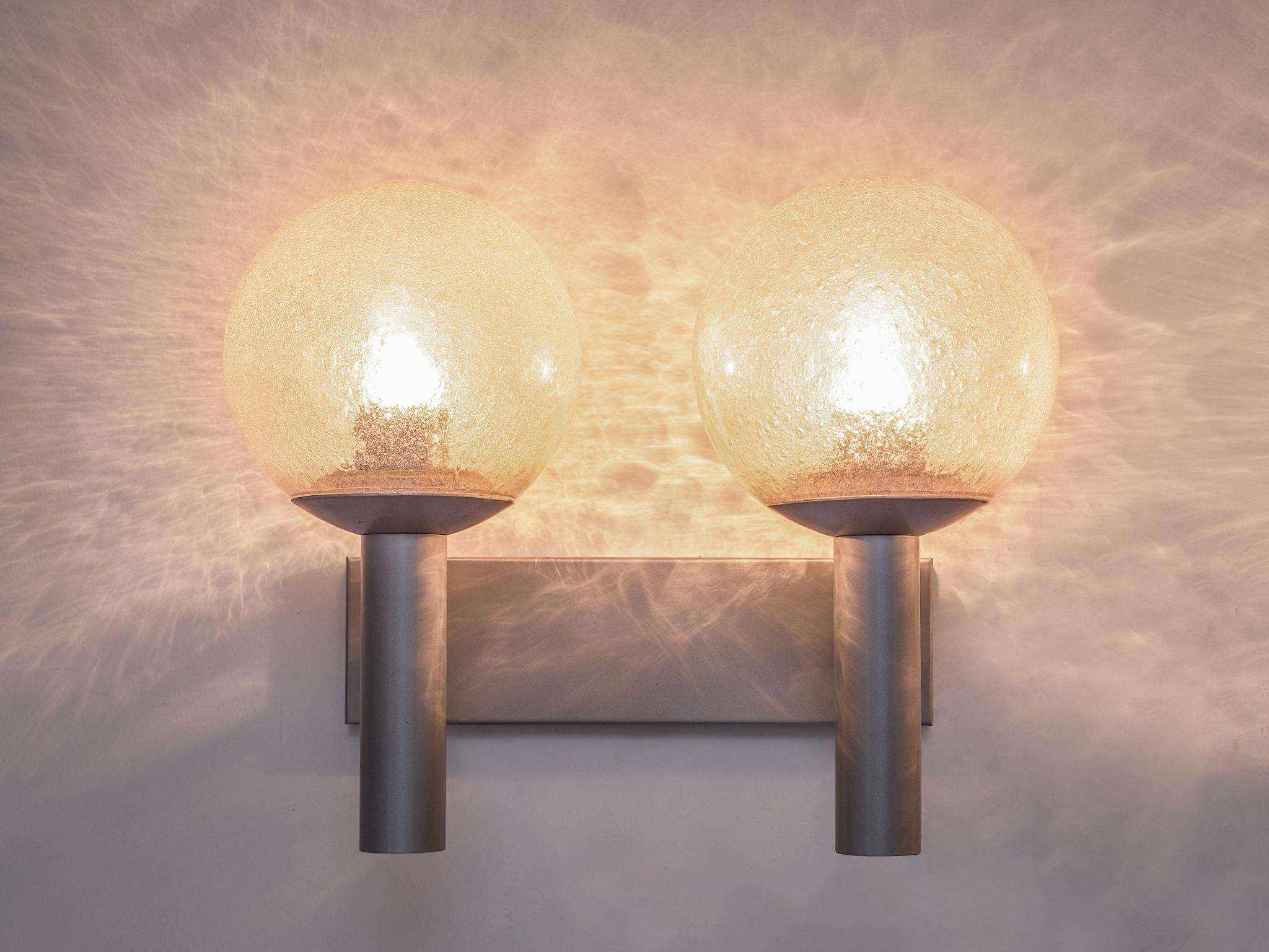 RAAK, pair of wall sconces, model 'C-1663' Vigilante, metal, glass, Europe, 1960s.

These lights have a simplistic design. It's strength is in the combination of the forms and materials. The fixture consists of a plate to which two tubes are