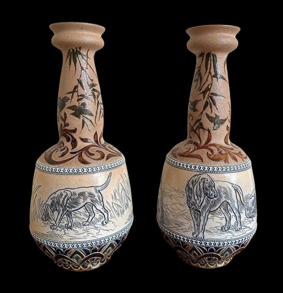 5411
Hannah Barlow and Florence Barlow for Doulton Lambeth, a Pair of Globe and Shaft Vases decorated with Blood Hounds between formal impasto borders, the neck decorated with a Pate sur Pate decoration of Birds.
31cm high, 13.5cm wide
1880 - 91.