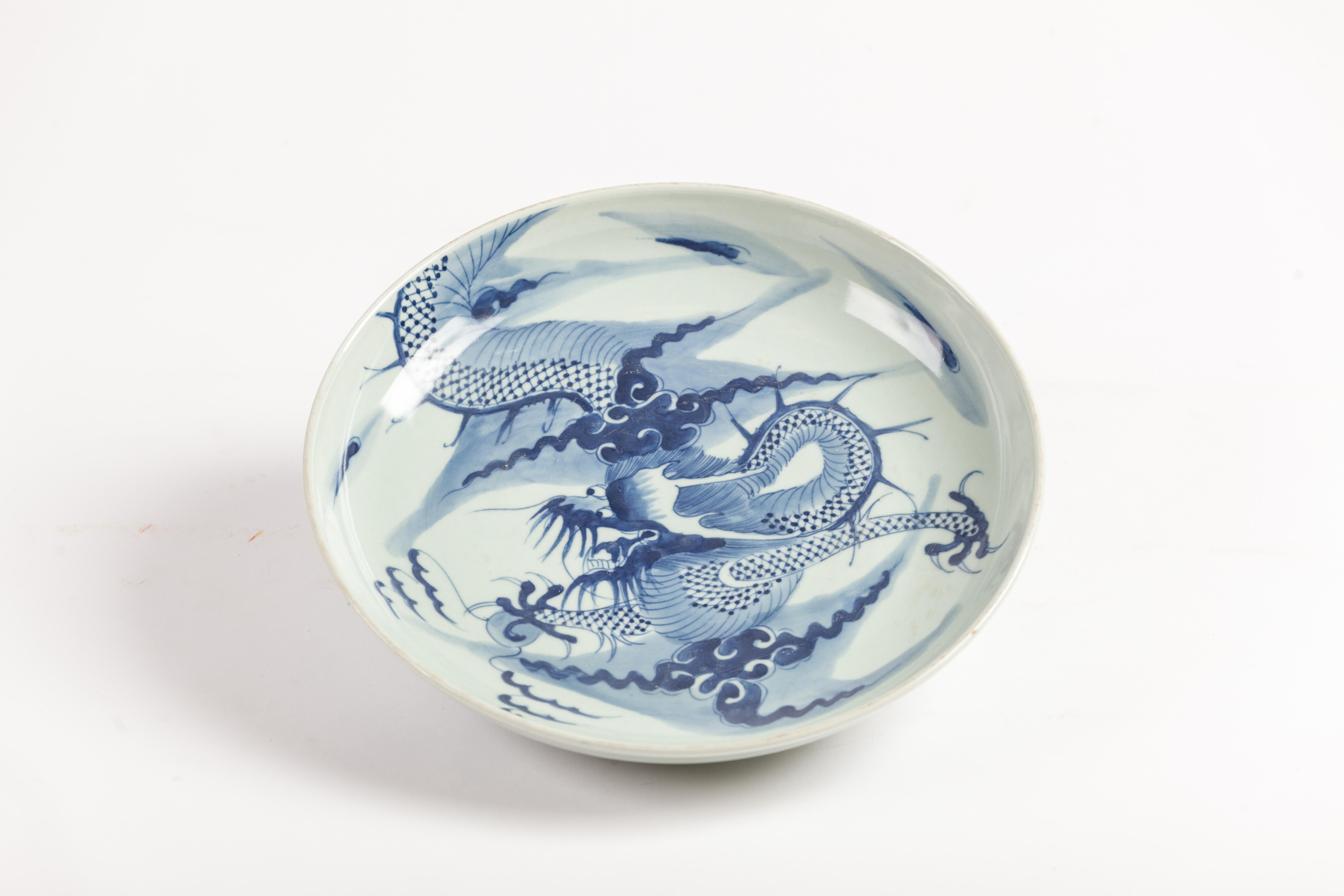 Pair of blue and white chargers with dragon art.