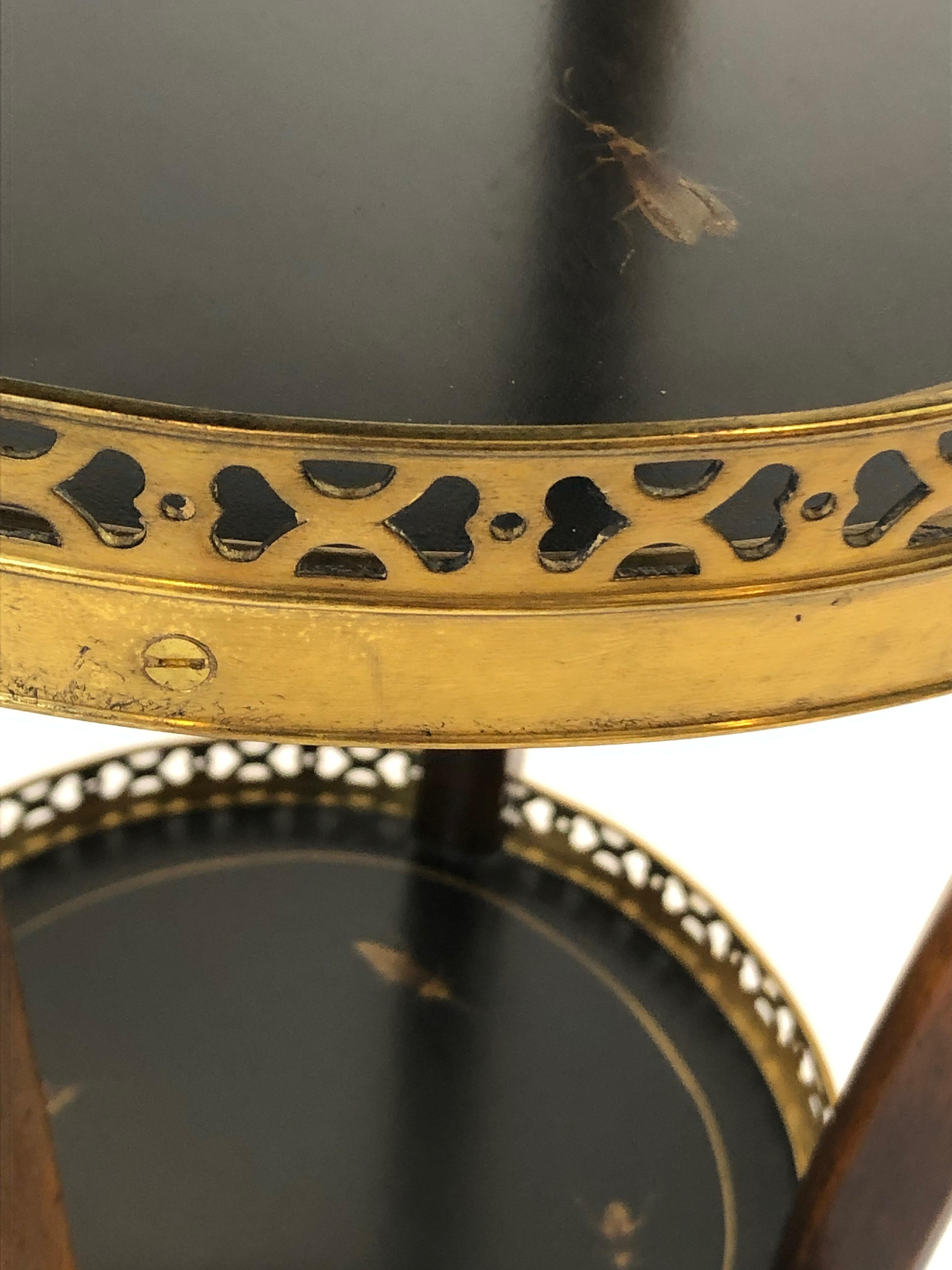 A pair of dramatic circular 4 tier stands having mahogany frames, ebonized and hand painted shelves with brass galleries, and beautiful brownish gold renderings of assorted insects.
Top level 12 inches diameter; #2 14 inches #3 13 inches #4 10