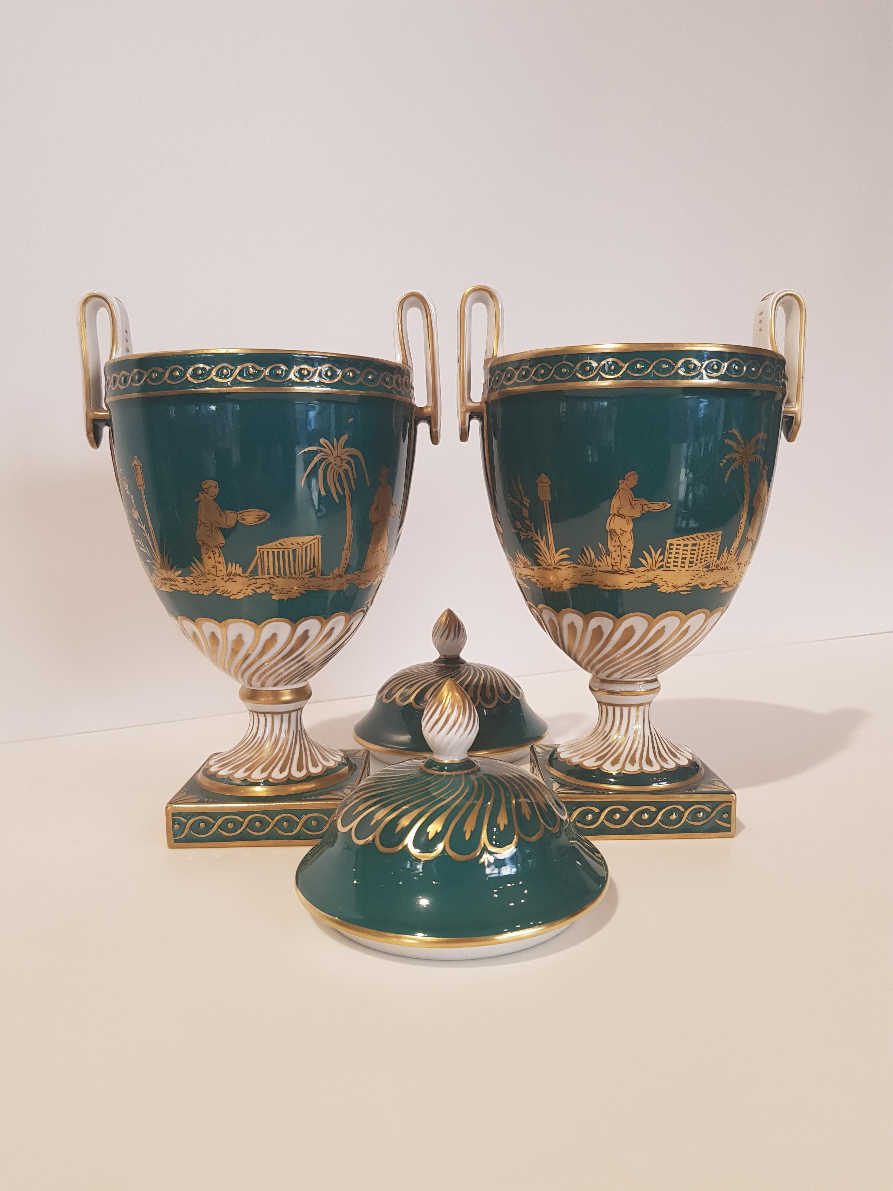 Pair of white German ceramic vases from Dresden, made and decorated by hand.
The vases are characterized by an intense green background with contrasting decorations of gold that represent the Nativity.
The vases have a lid with a pinecone grip and