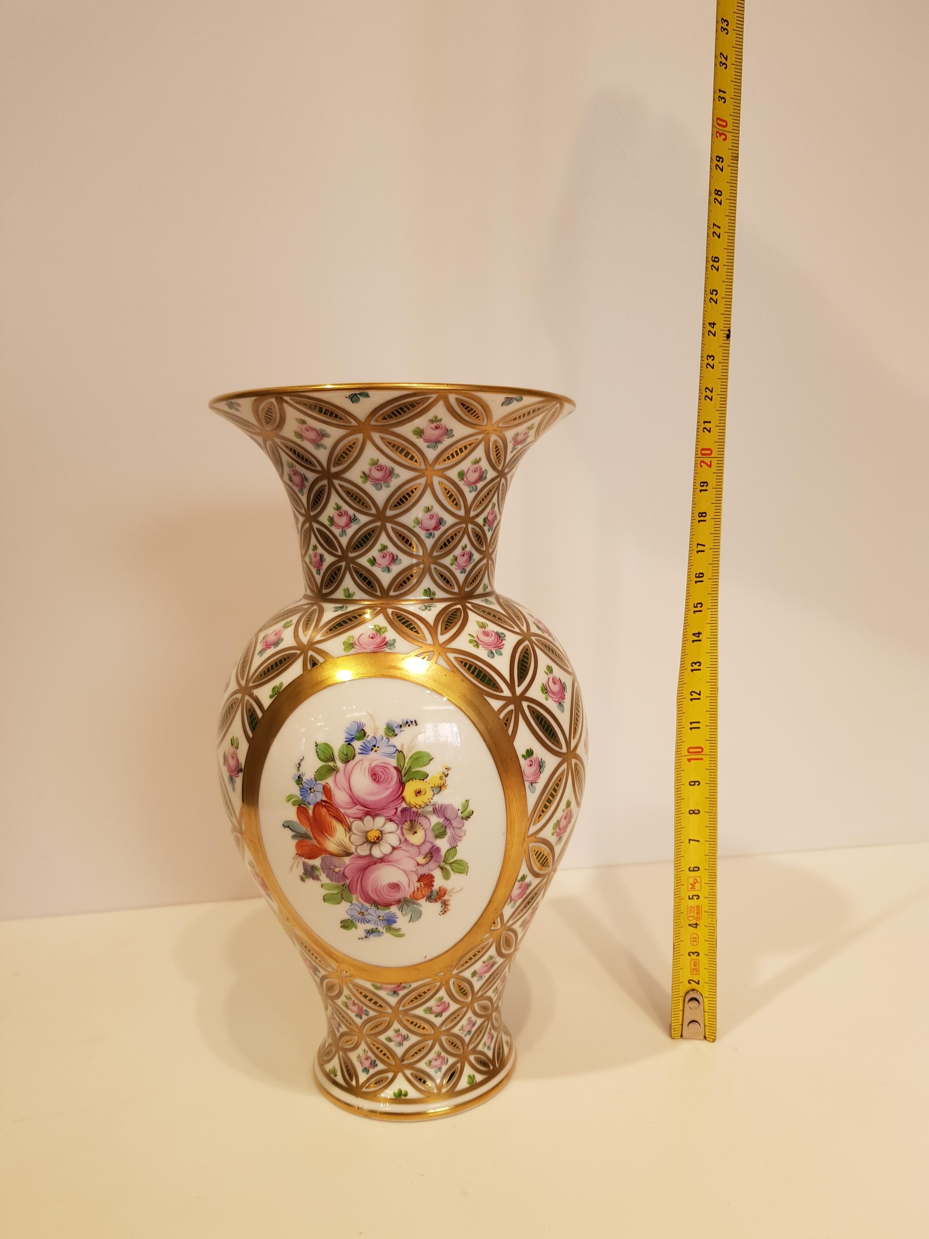 Pair of German porcelain vases from Dresden.
These vases are finely hand painted with particular geometric patterns in gold that frame the central floral motif.
Two objects of high artistic work full of details, with bright colors but at the same