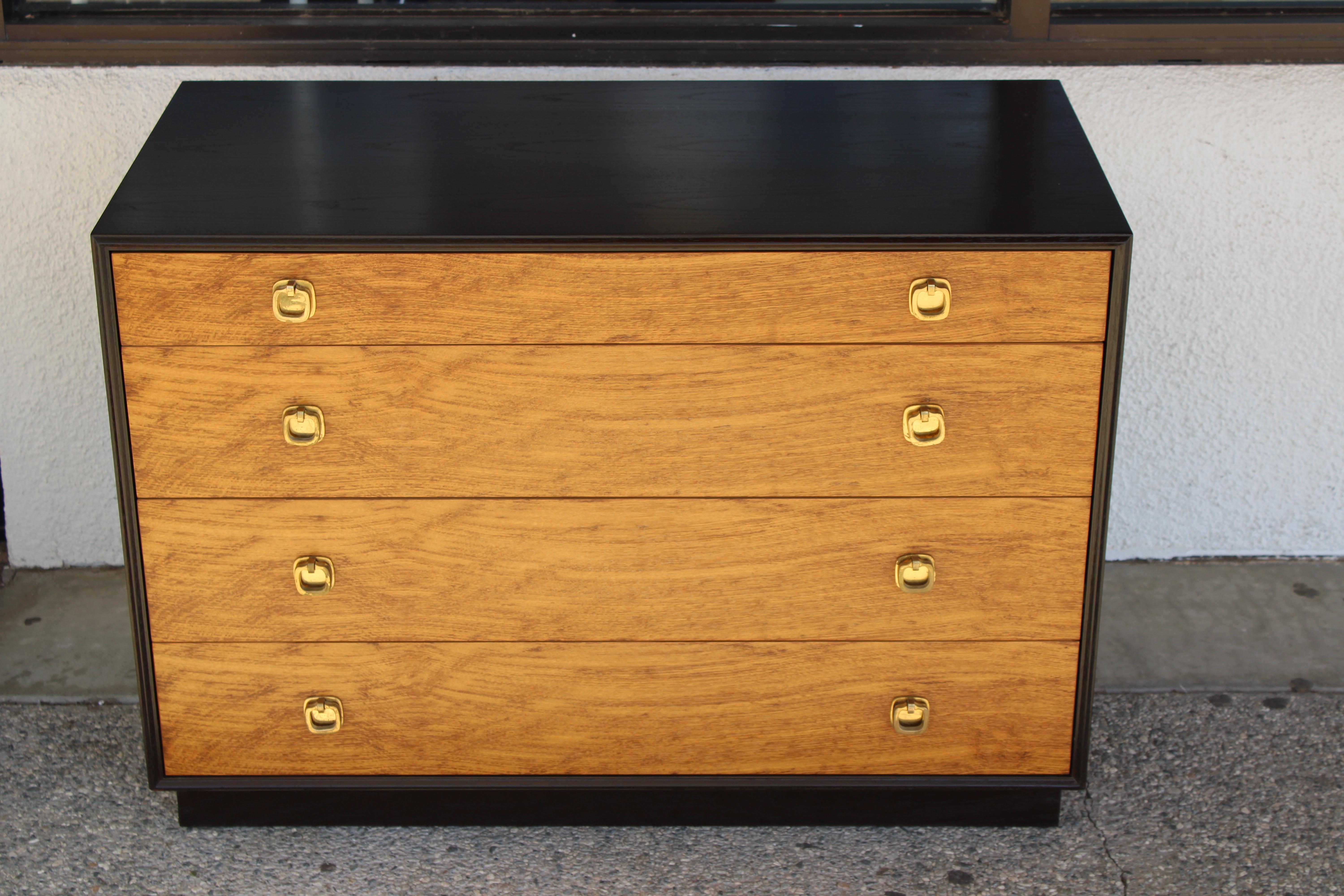 Pair of dressers with brass pulls by Edward Wormley for Dunbar, Berne Indiana.  Each dresser has 4 drawers with white laminate lined interiors.  Dressers measures 36