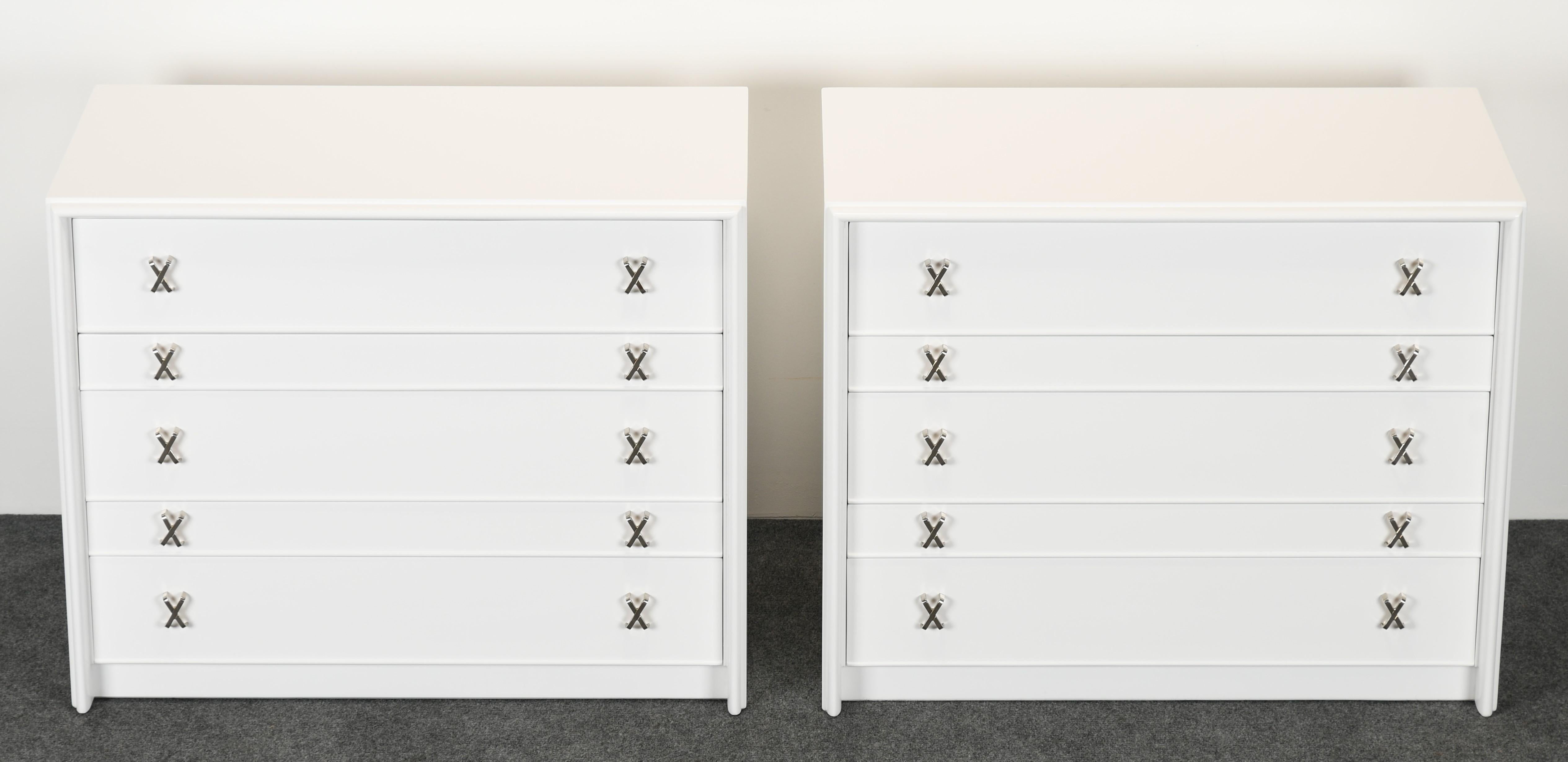 An elegant pair of Paul Frankl five-drawer dressers in excellent newly restored condition. Refinished in a durable Italian catalyzed finish. Polished nickel finish 