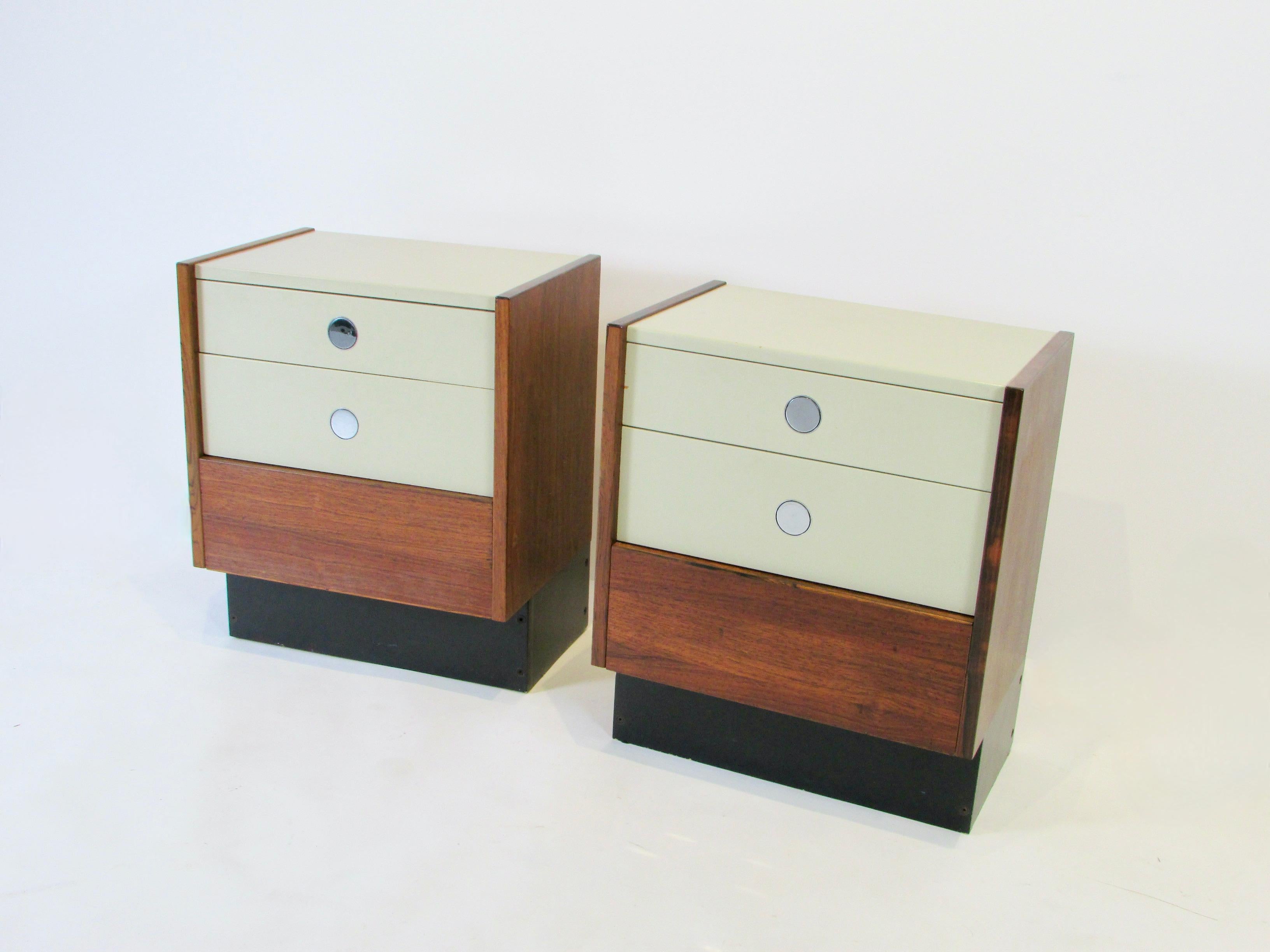 Drylund of Denmark bed side tables or night stands. Pair of rosewood cabinets hold lacquered drawers with chrome disc pulls.