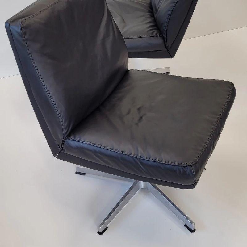These Highly sought after vintage De Sede DS35 Executive Chairs make a perfect seating duo, rarely seen as a pair.

Produced in the early 1970s by Swiss De Sede Craftsmen, in pristine unmarked condition. Recently re covered, the soft black leather