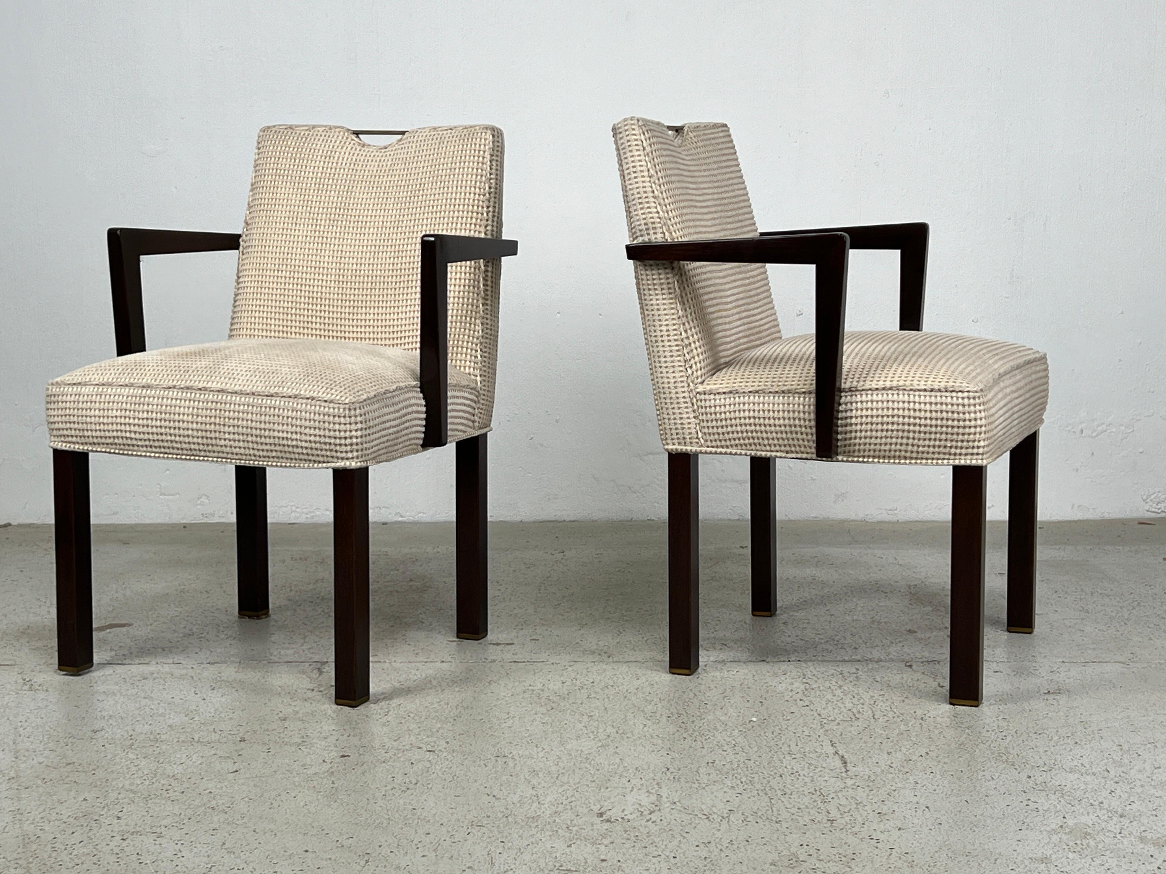 A pair of Edward Wormley for Dunbar armchairs with brass handles and brass feet. 