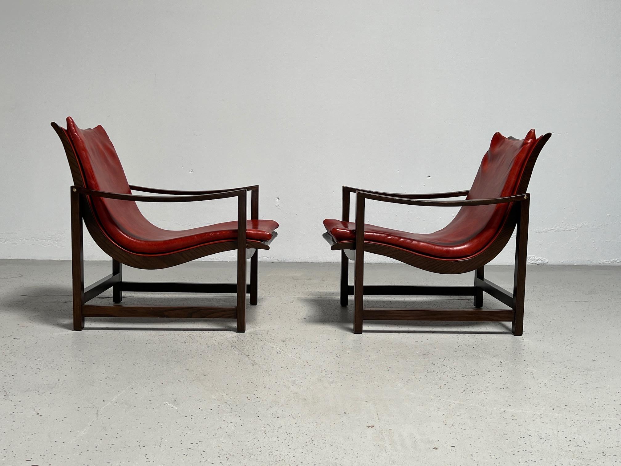 A pair of rare lounge chairs model 609 designed by Edward Wormley for Dunbar. Original leather-like vinyl upholstery on Ash frame with brass hardware.