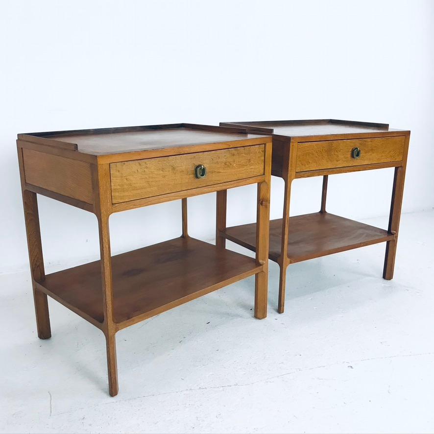 Pair of oak and ash nightstands with original brass hardware. Designed by Edward Wormley for Dunbar. Some surface scratches/marks - refinishing is recommended.