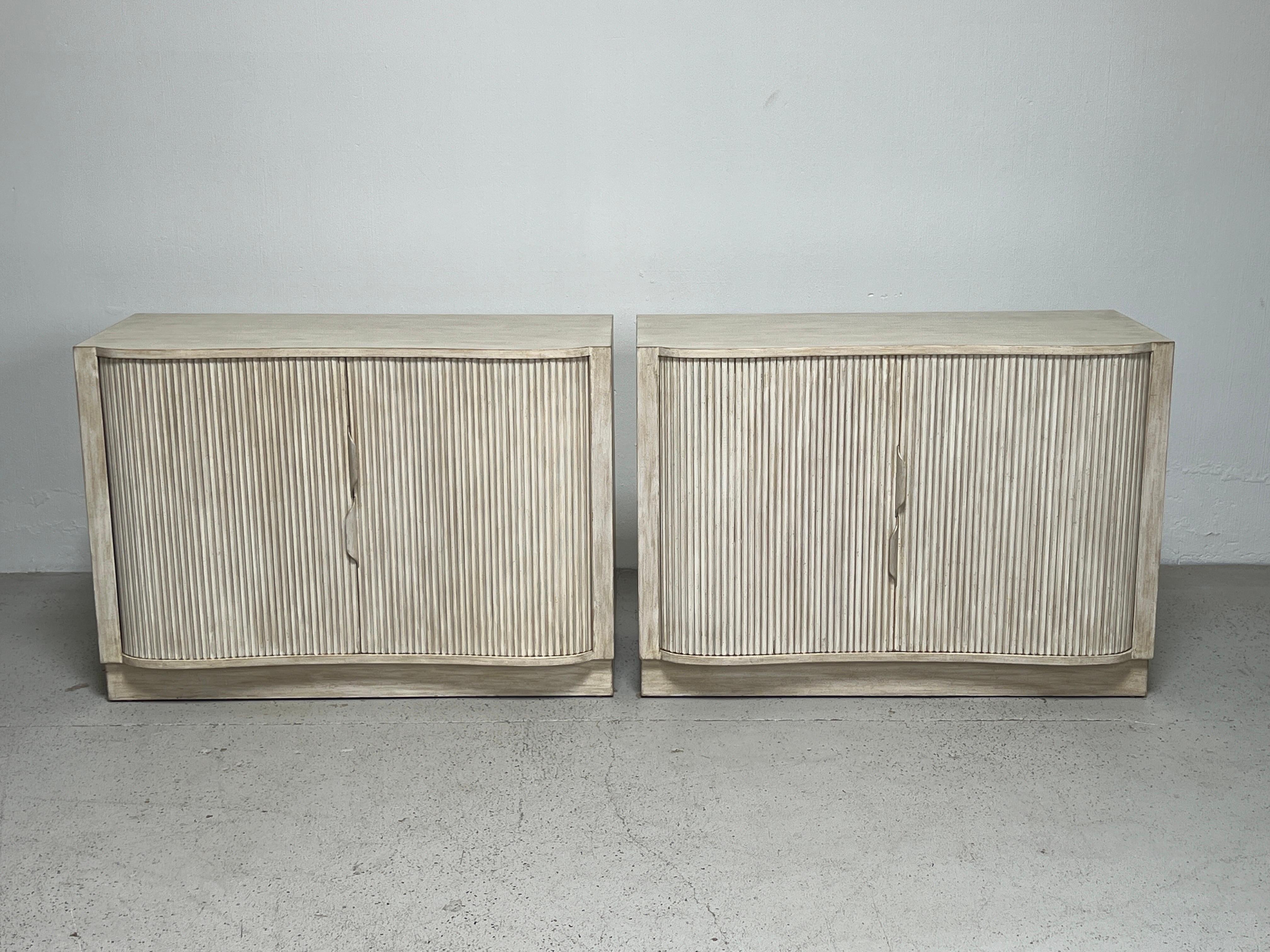 A pair of cerused tambour door serpentine cabinets designed by Edward Wormley for Dunbar.