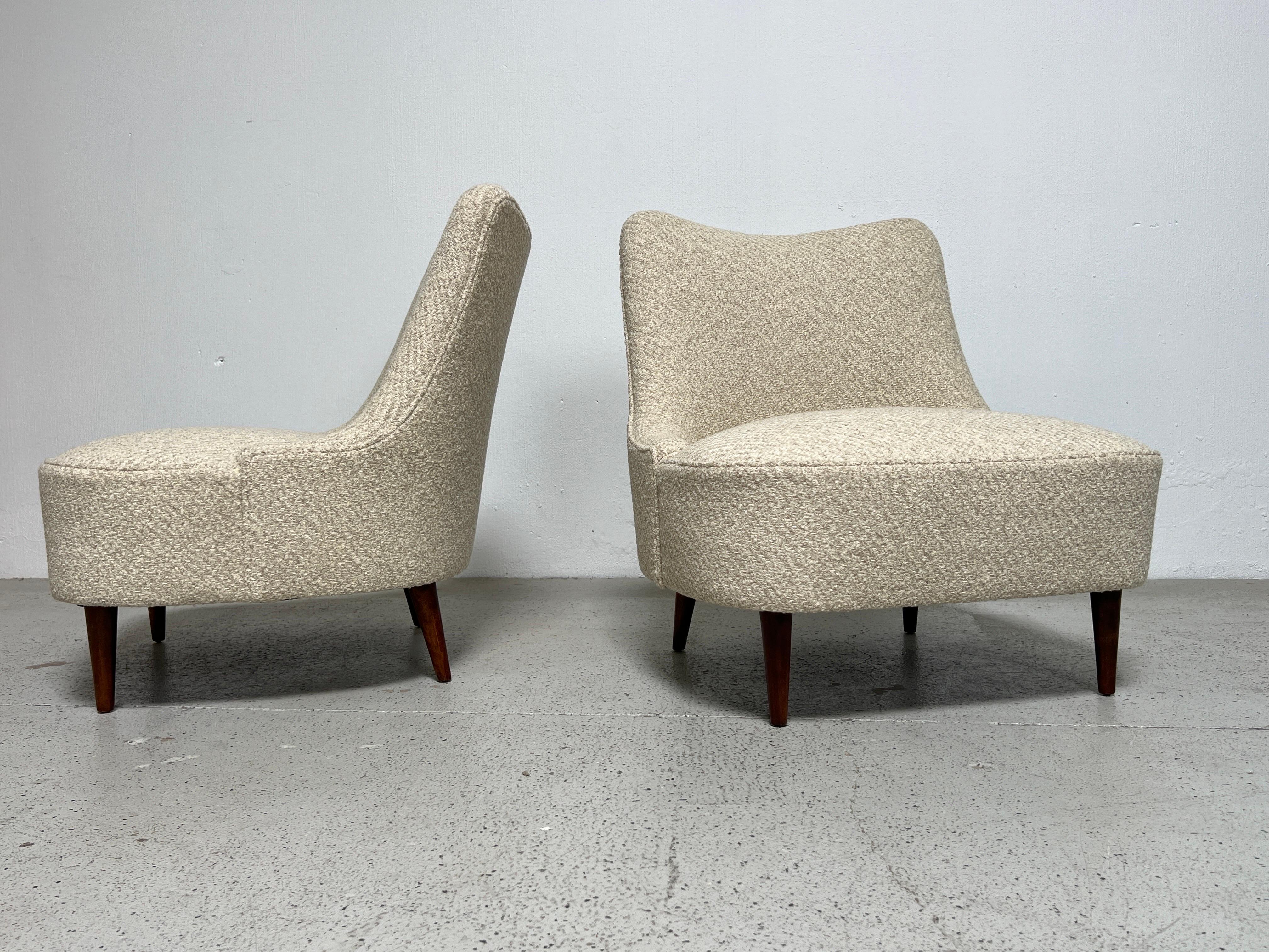A pair of early teardrop slipper chairs with walnut legs. Designed by Edward Wormley for Dunbar.