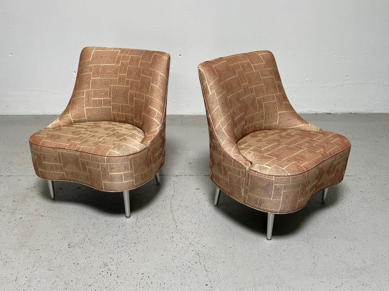 A pair of teardrop slipper chairs with aluminum legs designed by Edward Wormley for Dunbar. These are from a newer production made in the last 15 years.