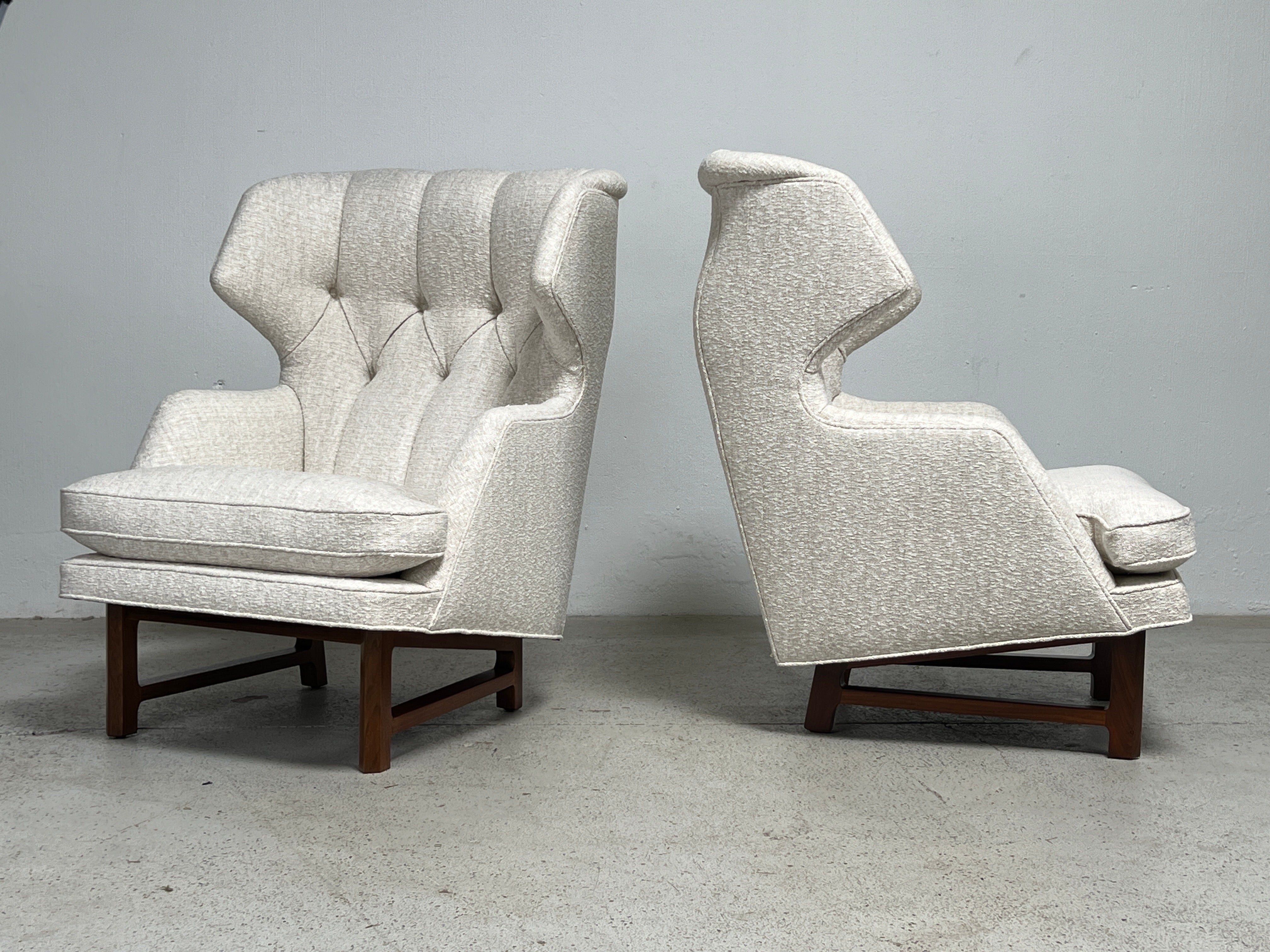 A pair of wing back Janus lounge chairs designed by Edward Wormley for Dunbar. Fully restored and upholstery in Kravet / Heritage Weave / Linen. 