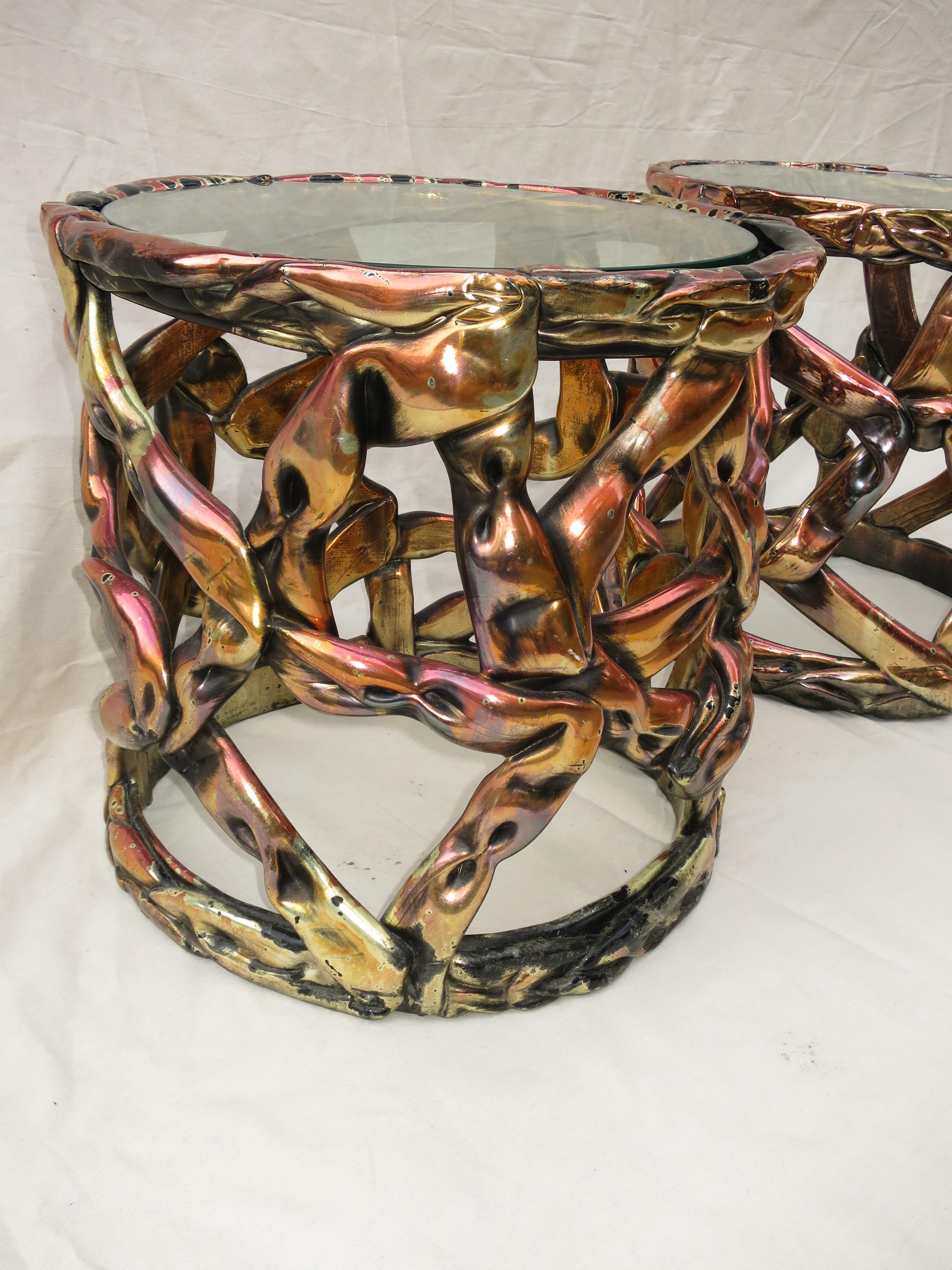 Pair of Ribbon side tables of extruded resin with gold and brass warm tones, with inset glass top.
A style created by Tony Duquette, Hollywood designer.