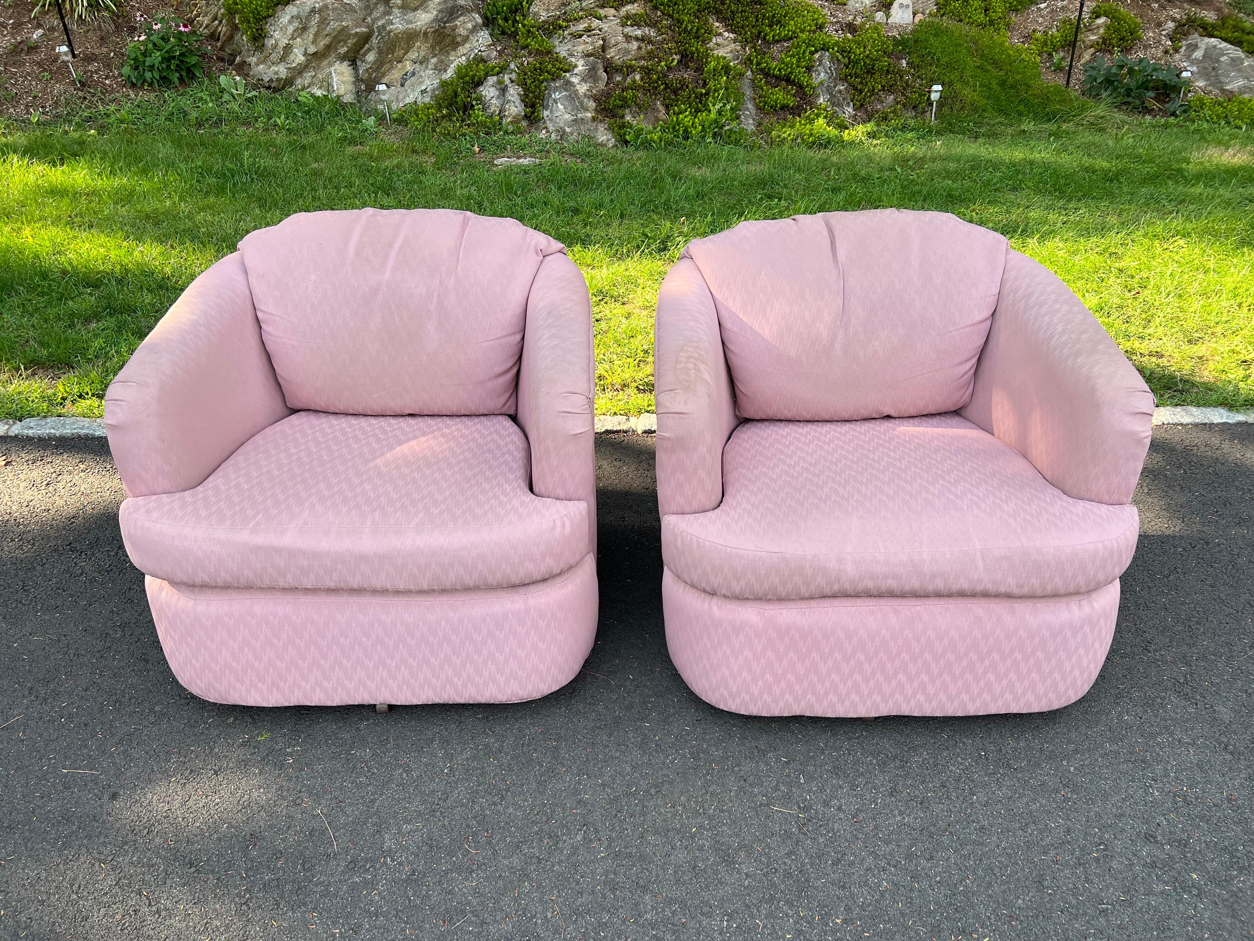 Pair of dusty rose swivel chairs. Fabulous golden girls style. Wooden construction. Nice wide and round shape with a low profile. Classic 1980's-90's Post Modern feel.