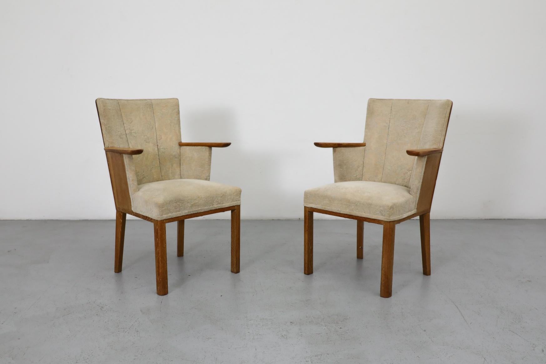 Pair of Deco Salon chairs in oak with original light patterned velvety fabric. By Dutch designer C. De Jong for J.A. Boskamp En Zonen, these deco chairs have angle paneled backs with short arm rests. Originally used around a round pedestal table for