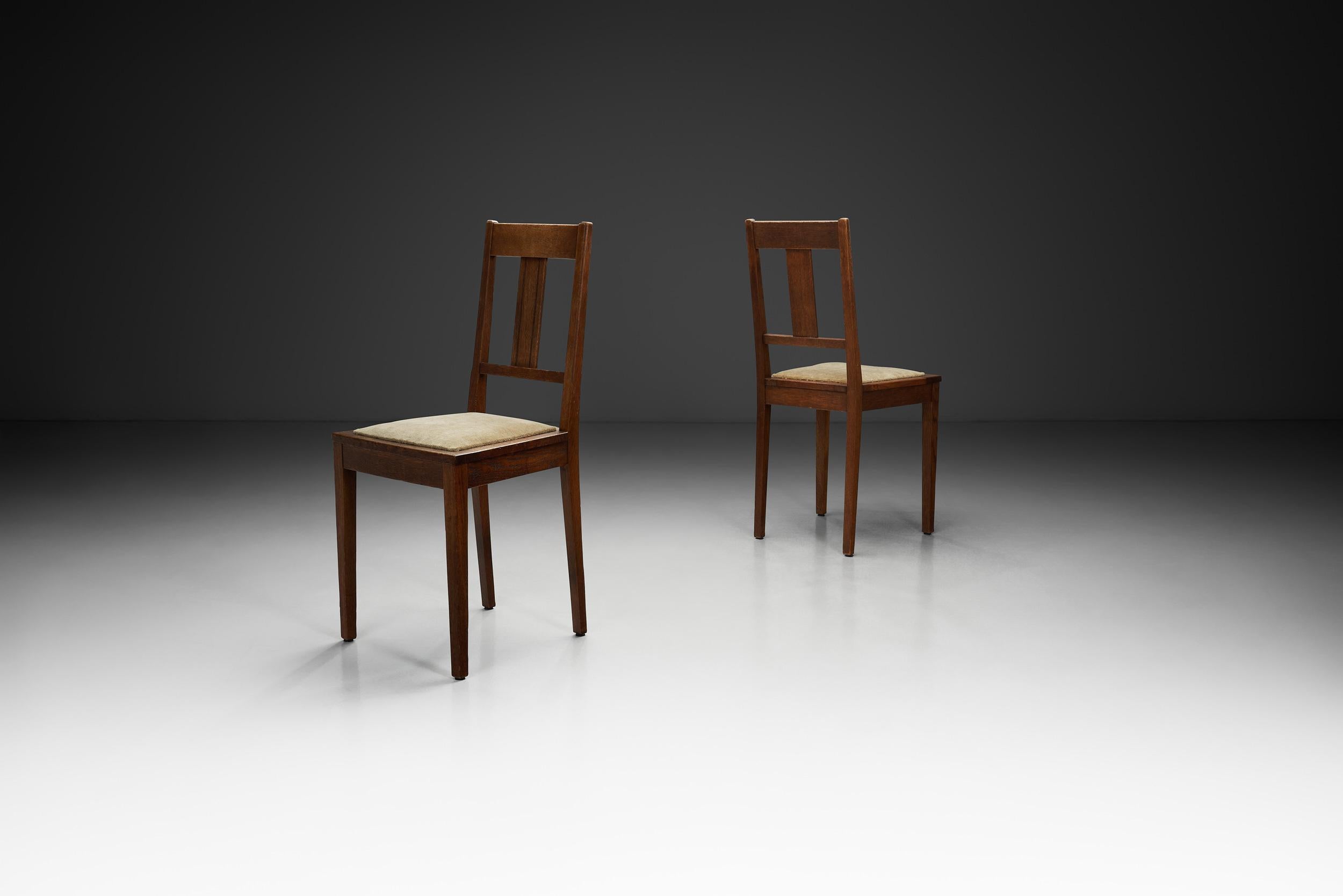 This striking pair of Dutch chairs were crafted during the 1930s and embody the crisp geometry and streamlined elegance typical of the period. These chairs are a perfect blend of functionality and aesthetics.

Constructed from solid wood, the chairs