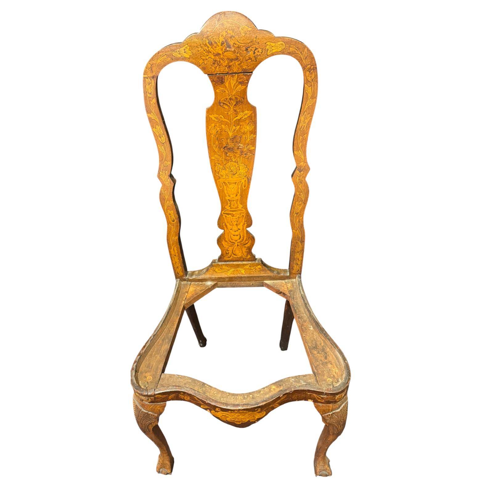 Pair of Dutch Baroque style marquetry side chairs featuring drop-in seats and  inlaid marquetry details. Each chair displays a shaped crest rail above a back splat richly decorated with floral motifs, birds, urns, and foliage. The central splats