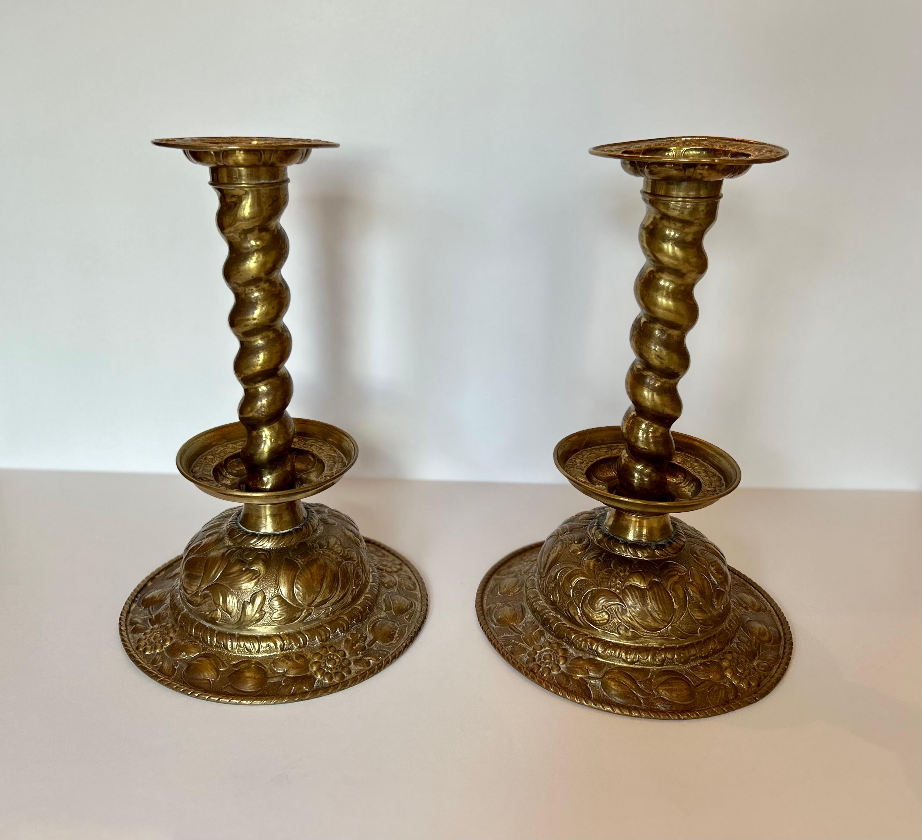 Spectacular pair of large brass candlesticks in the Dutch manner, nineteenth century or earlier. Either Dutch or Swedish. 1500These candlesticks feature beautifully embossed flowers throughout with barley twist shafts, removable drip pans and a
