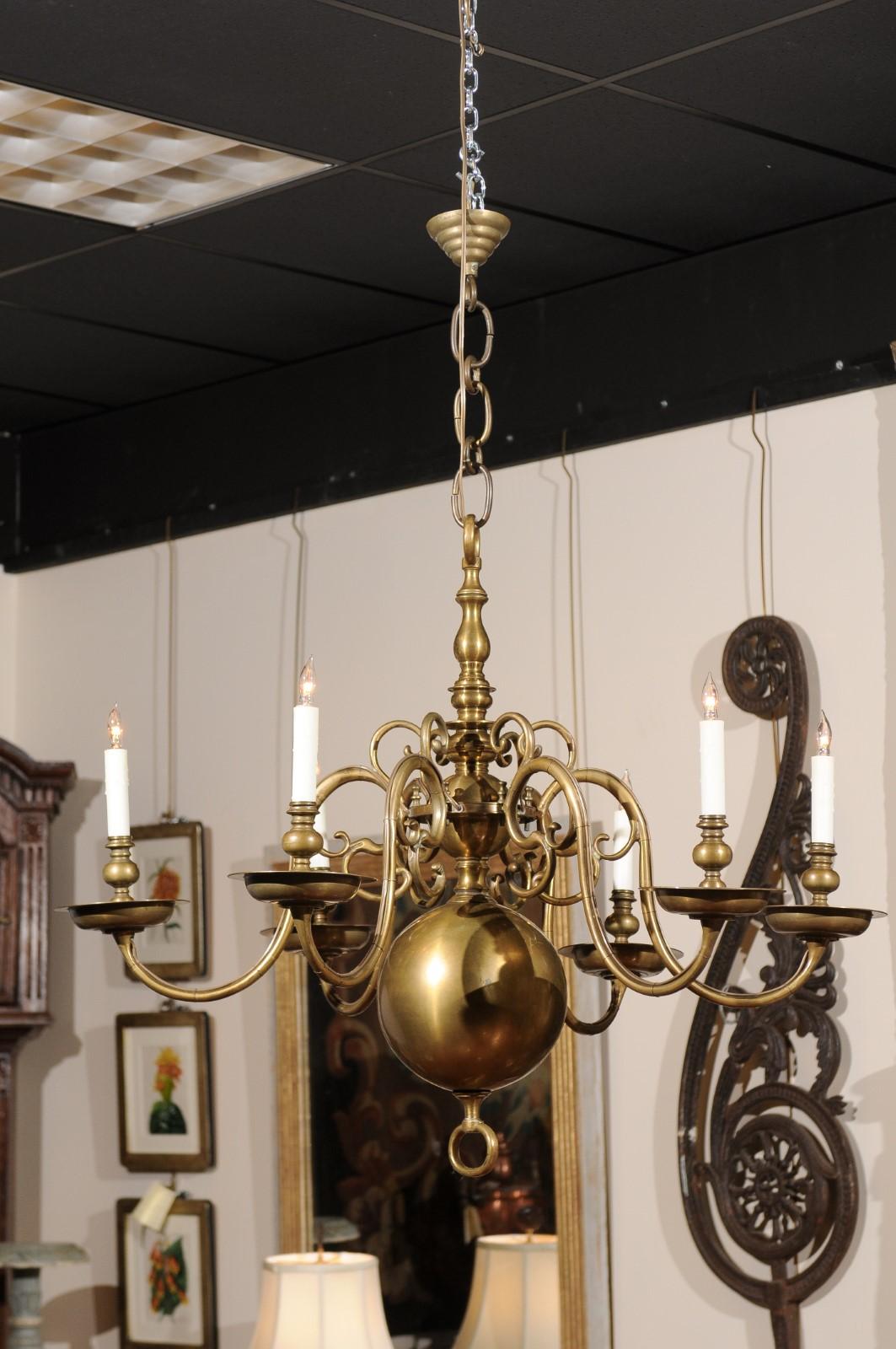 The pair of Dutch Colonial chandeliers with 6 scrolled decorated arms and bobeches, center bublbous column, and terminating large ball with ring finial. The chandeliers recently wired for USA electricity.

 