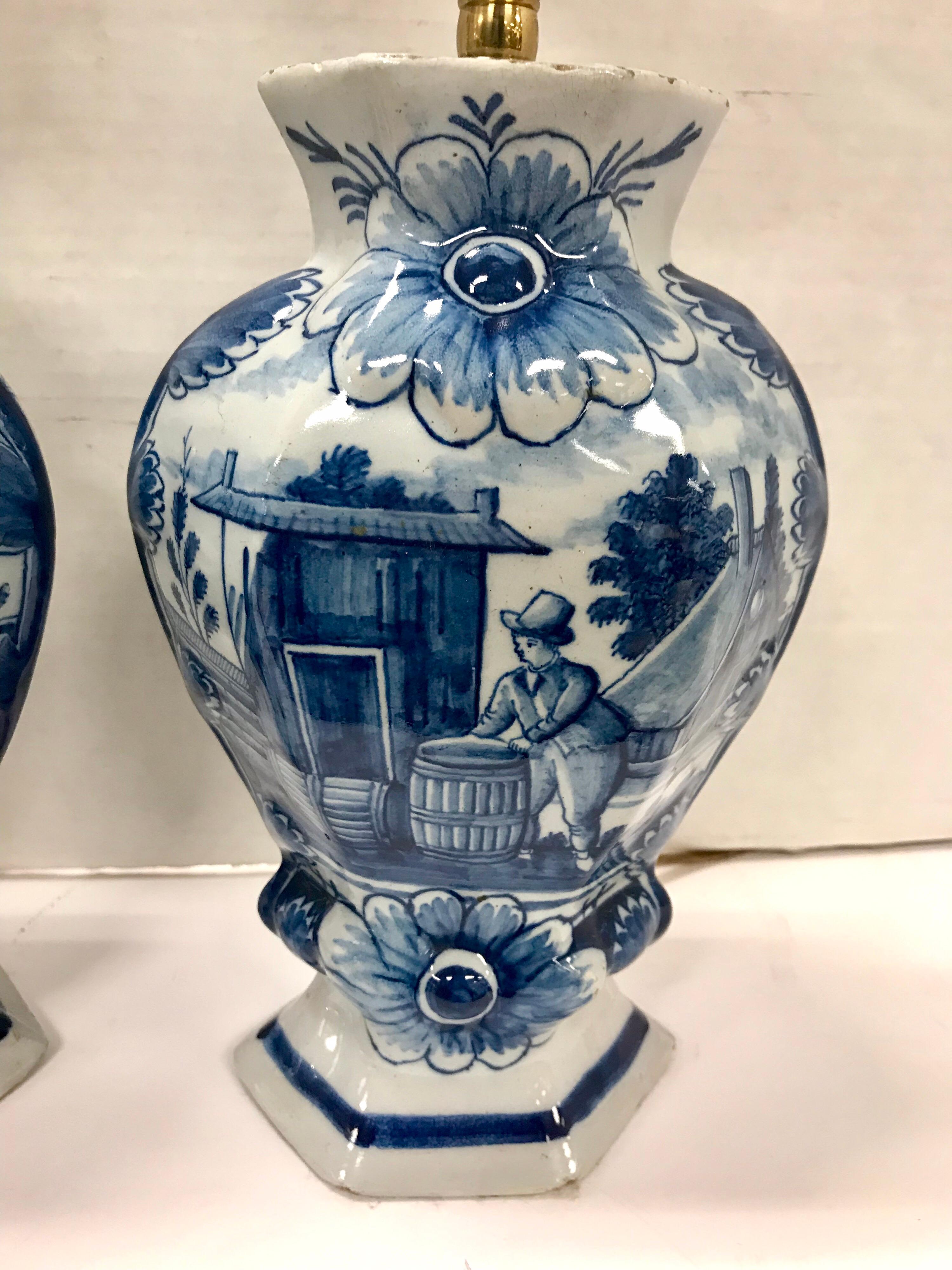 Beautiful pair of matching Delft blue and white vases turned into table lamps. Each fitted for two bulbs. Wired and in working condition. The base has felt protector.