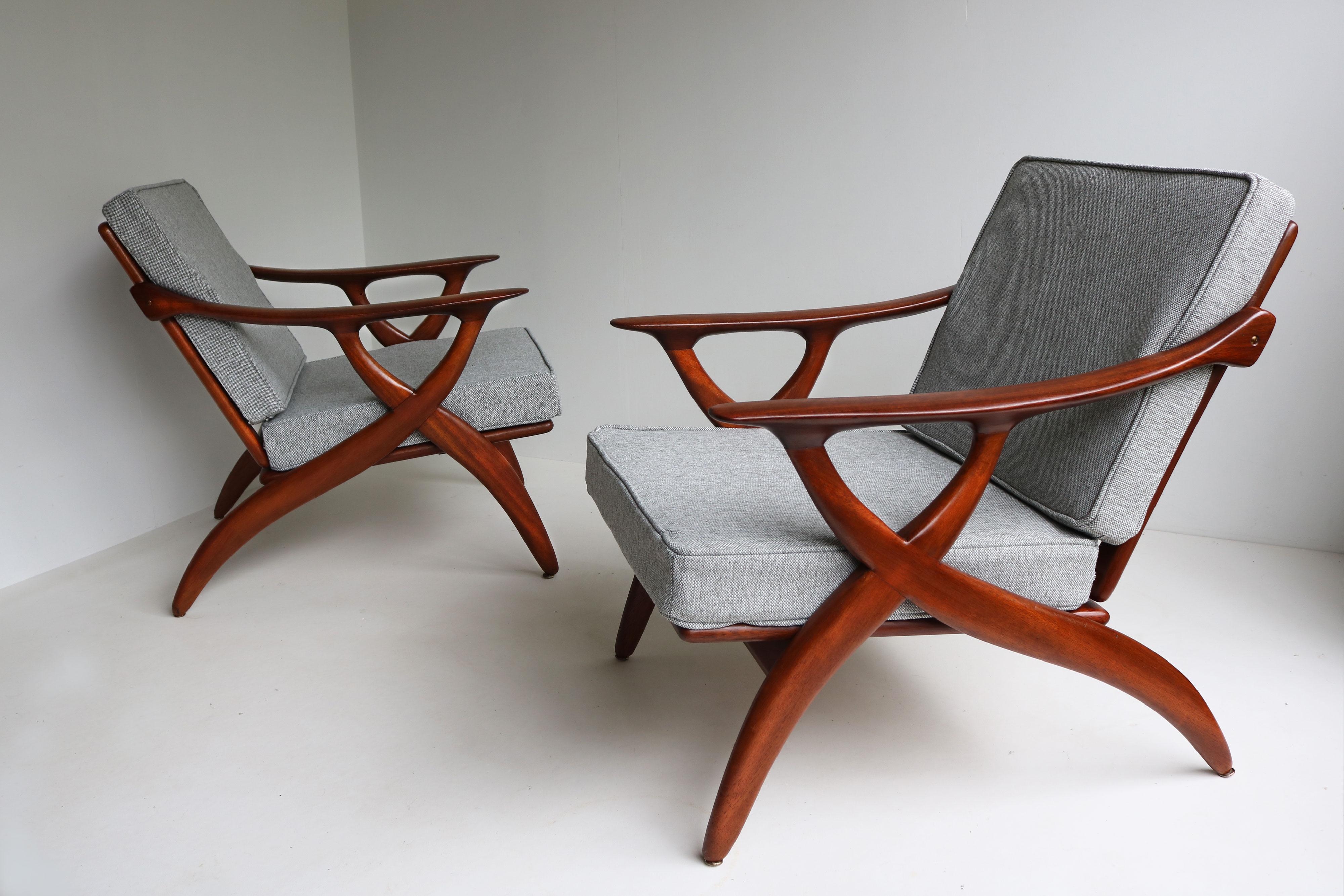 Elevate your living space with a pair of De Ster Gelderland design lounge chairs, a stunning example of mid-century modern craftsmanship from 1950 Holland. Handcrafted from rich teak, these chairs feature beautifully organic-shaped frames that