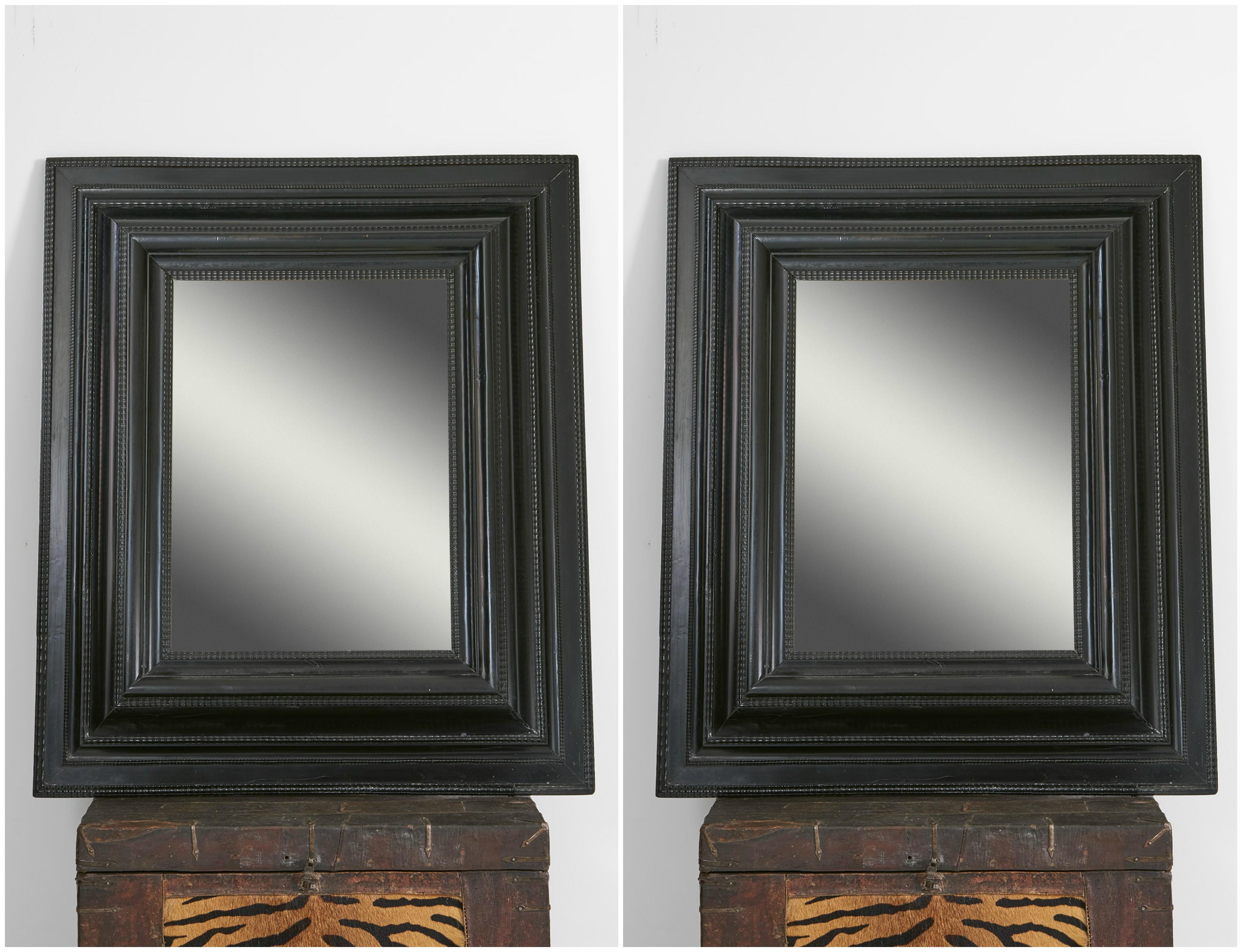 Carved Pair of Dutch Ebonized Cushion Frame Mirrors For Sale