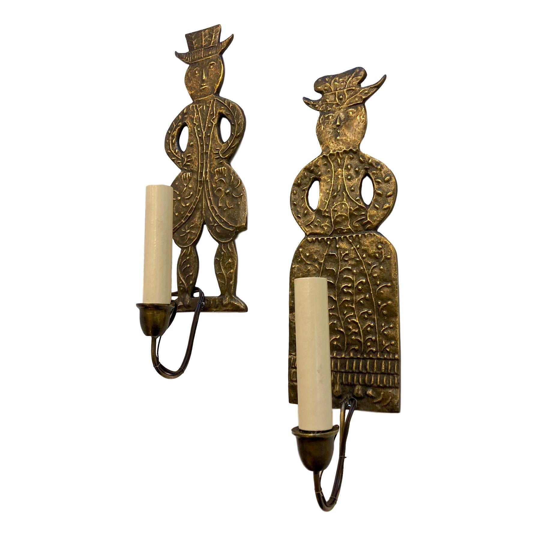 A pair of circa 1910 single-arm figurative Dutch sconces that have been electrified.

Measurements:
Height 14?
Width 4?
Depth 4?.