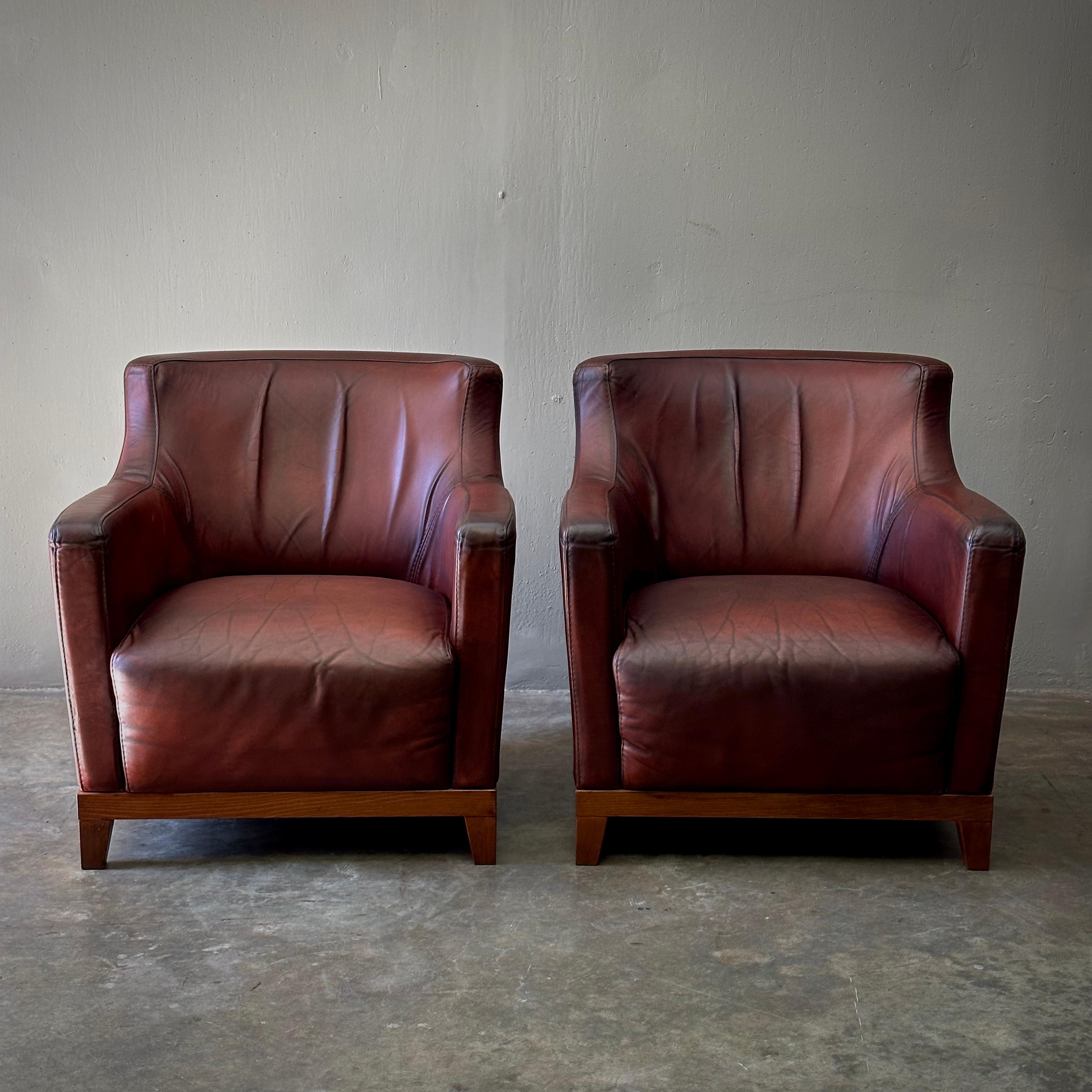 Pair of Dutch upholstered leather club chairs. Classic yet modern with a strong sculptural presence and softly contoured midcentury shape. The patina on the reddish chestnut leather is particularly exquisite. 

Netherlands, circa 1980

Dimensions: