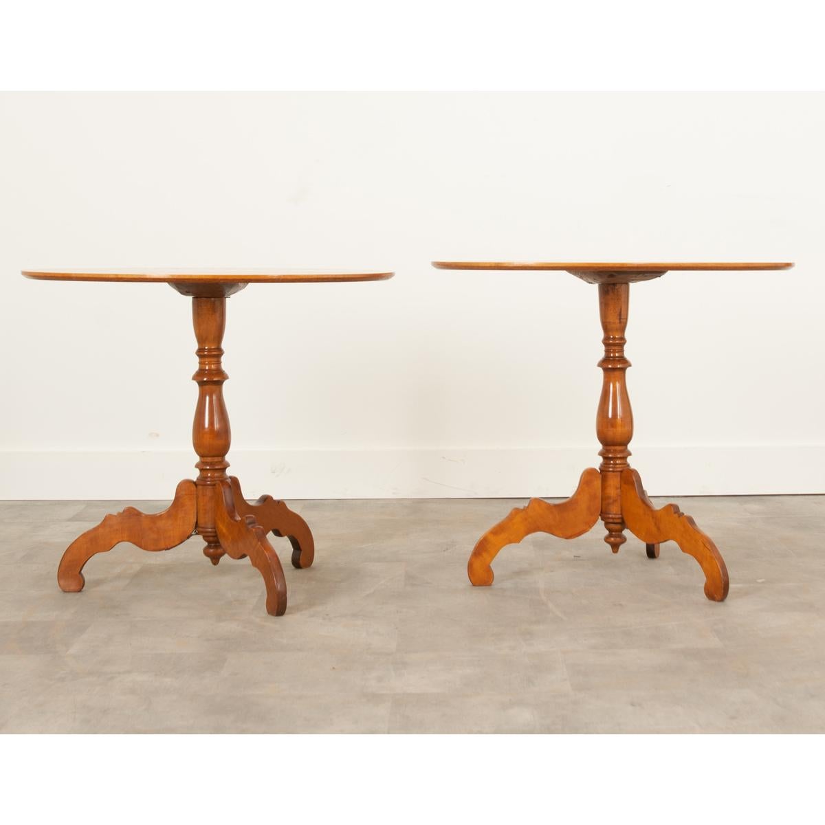 Pair of Dutch oval tables crafted in the 1800’s from gorgeous satinwood. In wonderful condition, they have been recently cleaned and polished with French wax paste to revitalize the vibrant wood. Their moderate size and classic design make it easy