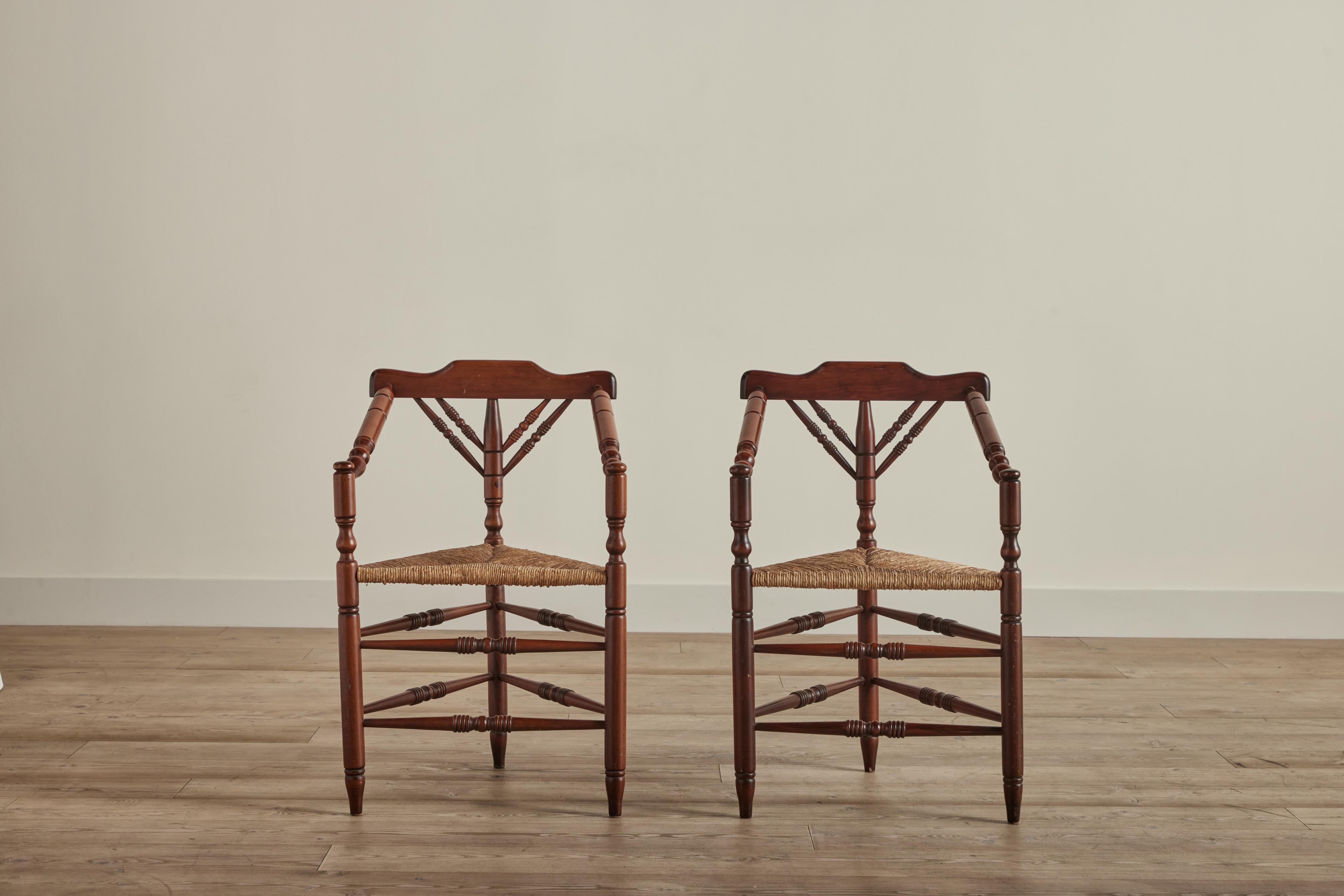 Pair of Dutch Turner’s chairs with rush seats circa 1960. This style of chair is known as a “Turner’s chair” because the chair frame parts, including the seat are turned on a pole lathe by a wood turner. Some wear on wood and rush that is consistent
