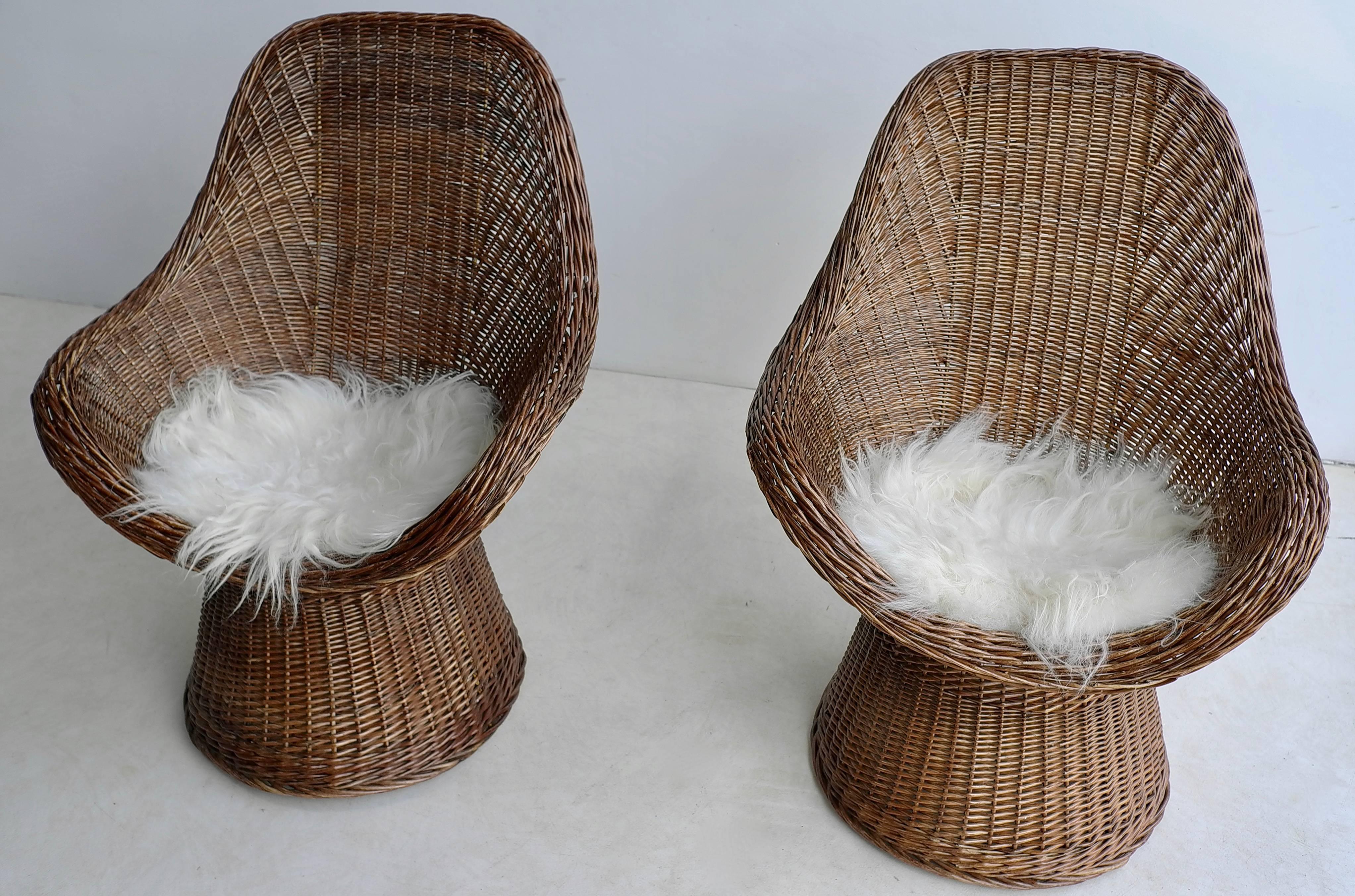 Pair of Dutch twined willow basket chairs with woollen seats, 1960s.

These chairs would look great inside an interior or outside on a porch.