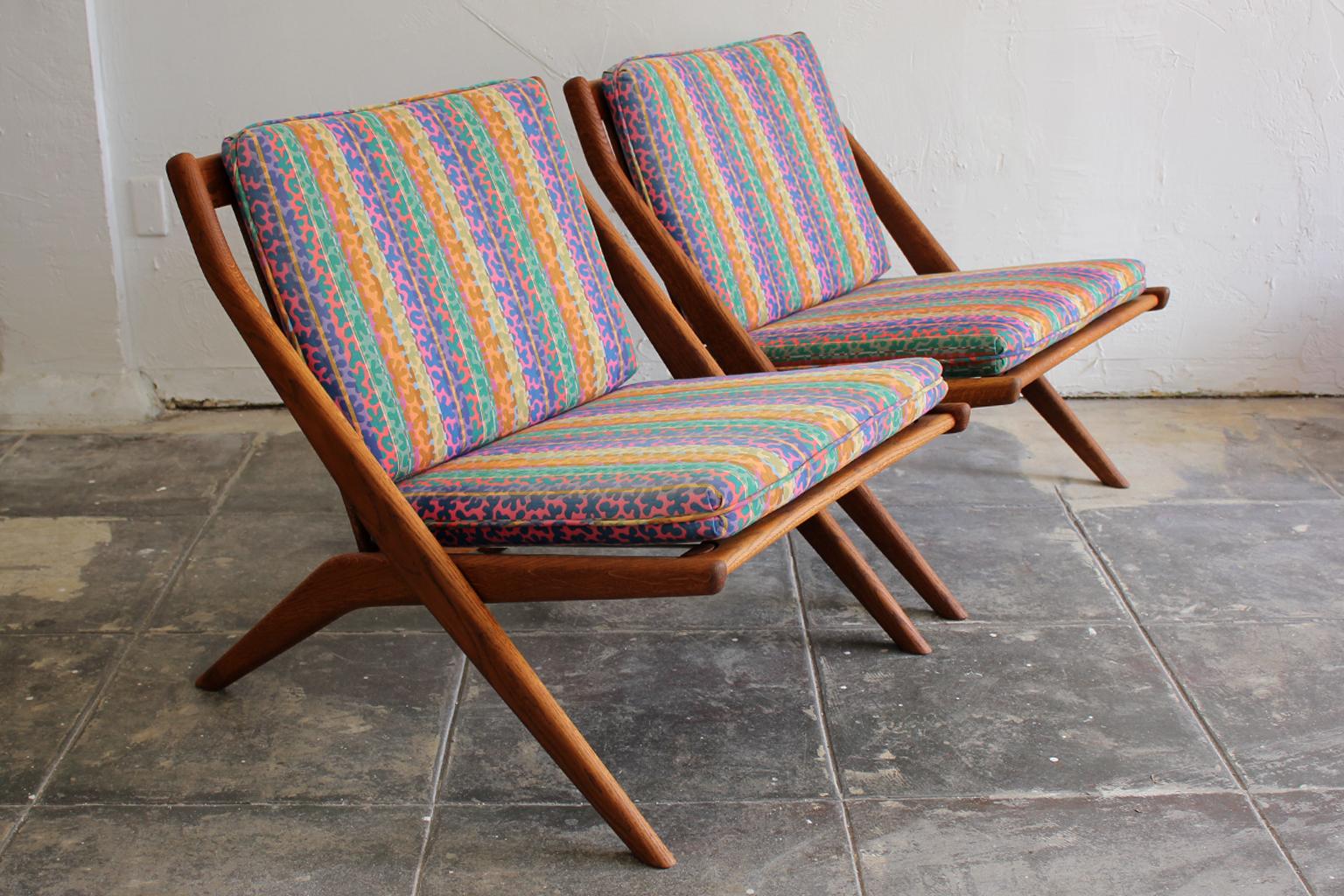 Beautiful pair of original DUX scissor lounge chairs designed by Swedish designer Folke Ohlsson, circa 1960s. The chairs have their original upholstery. Great colorful mod design. Reminds me of Jack Lenor Larsen or Missoni fabric. Some light fading