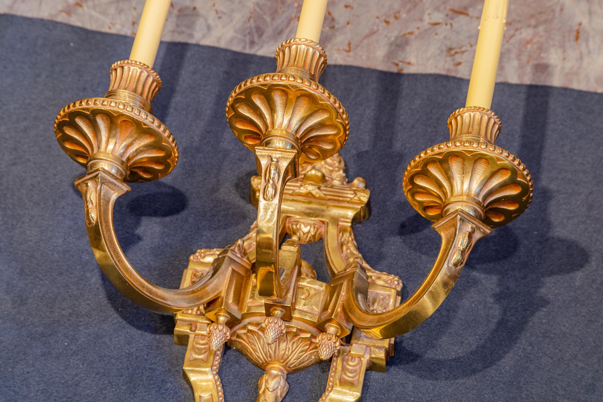 A large pair of French gilt bronze large Empire style three light sconces. Removed from a Paris theatre in the 1920's.