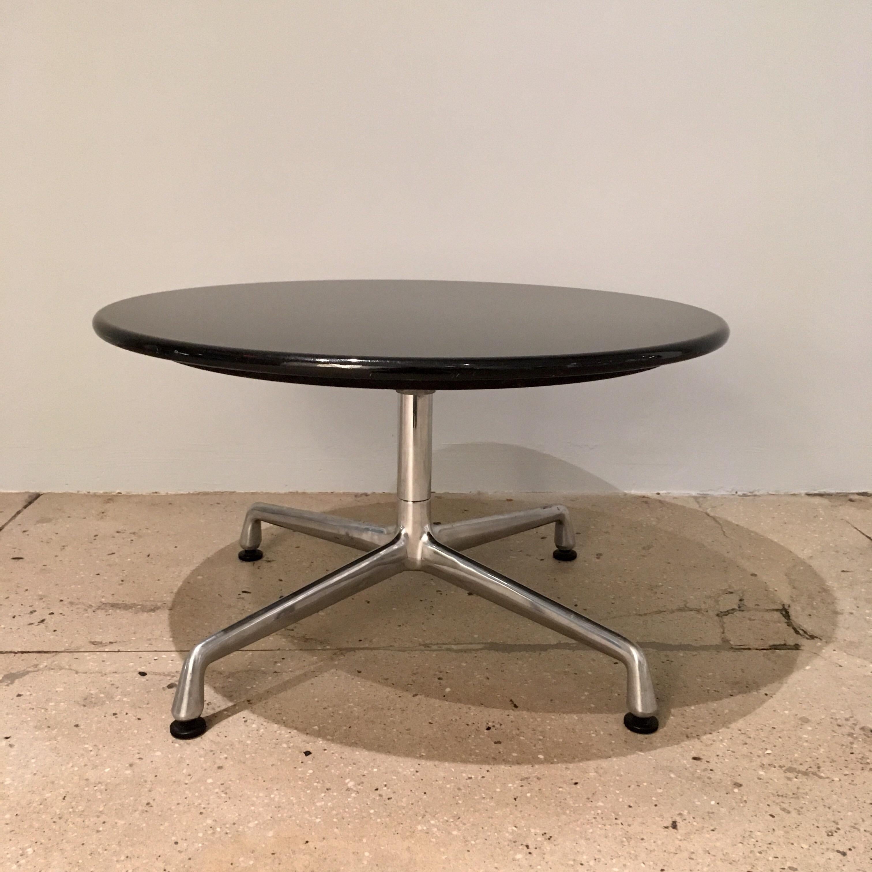 A pair of side tables composed of granite circular tops and sweeping aluminum legs design by Charles Eames for Herman Miller. Aluminum Group, 1960s.
