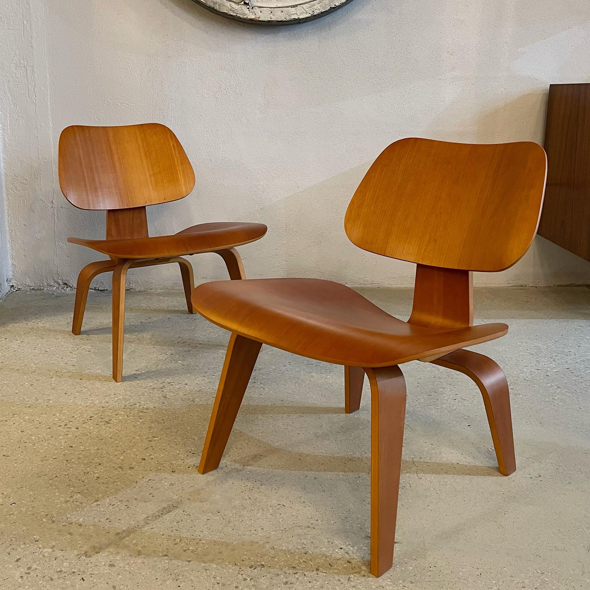 Pair of molded birch plywood LCW, low seated easy lounge chairs designed by Charles and Ray Eames for Herman Miller. Their black oval Herman Miller label indicates the pair is from the early 2000's. These organic, sculpted chairs are an iconic of
