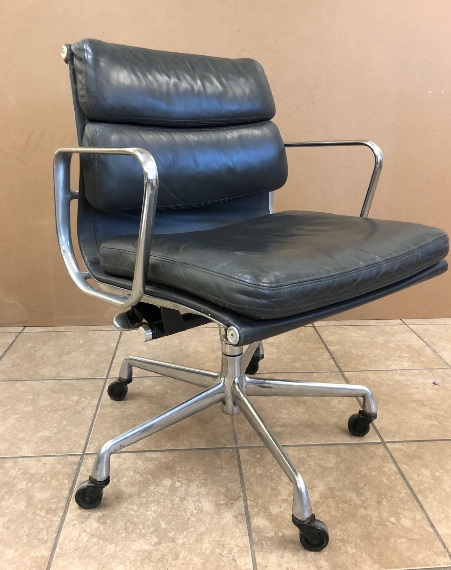 Pair of Eames for Herman Miller soft pad chairs in gray leather.