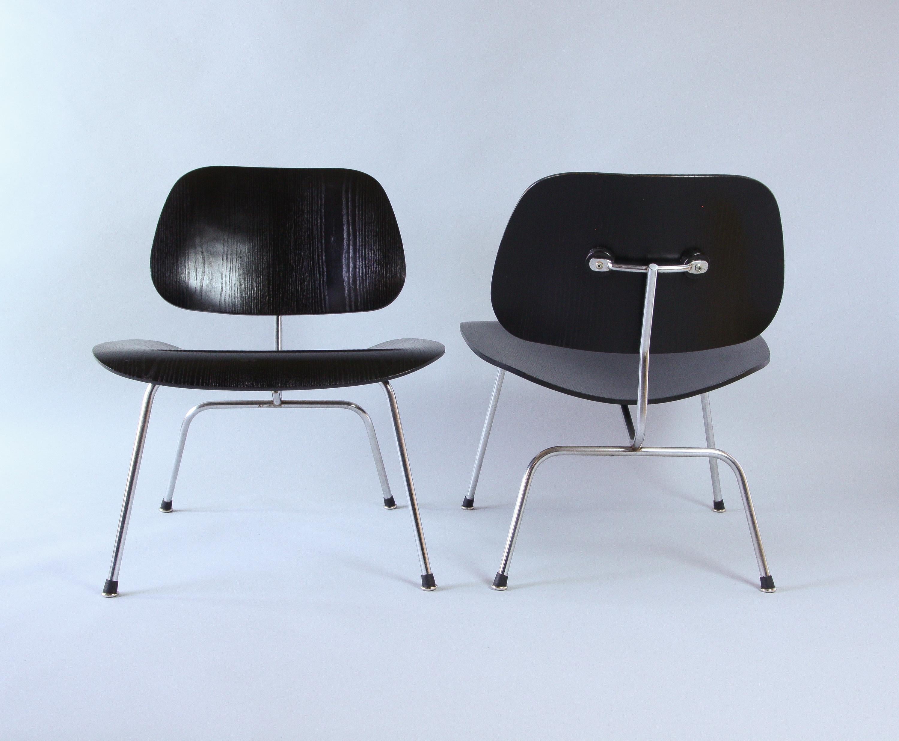 Two Eames LCM chairs in black and chrome, circa 1958. Great vintage condition showing age to the chrome with wear and scratching to the wood. Featuring the earlier style of angled rubber boot glides, these have been newly added.
In 1957 Wily