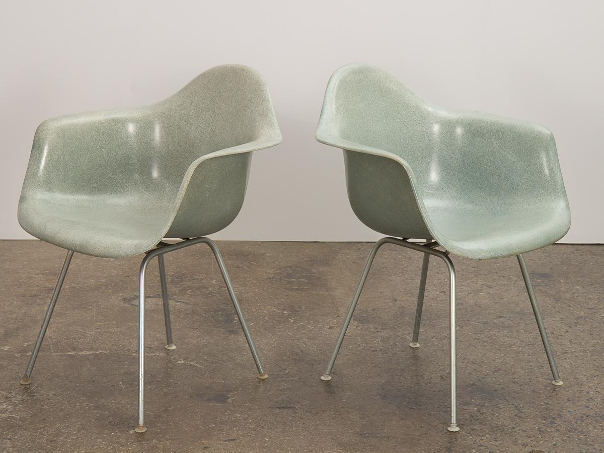Pair of original Eames fiberglass armchairs in scarce and desirable Seafoam colorway. An early 1950s version, each has a distinct thread texture that varies in saturation and density throughout the molded fiberglass surface. Acquired together and