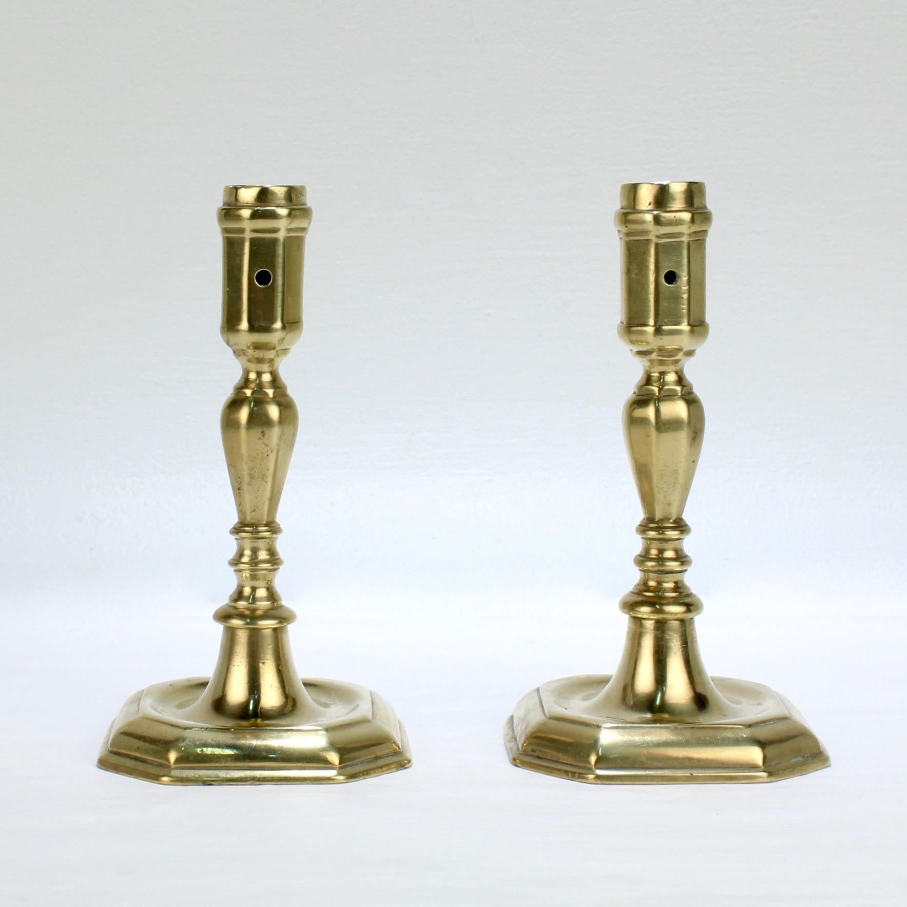 A very fine pair of 18th century brass candlesticks.

Each with an octagonal base supporting faceted stems and candle cups. (Each candle cup has a hole for wax removal.)

Simply an elegant period candleholders!

Measure: Height ca. 6 1/2 in.

Items