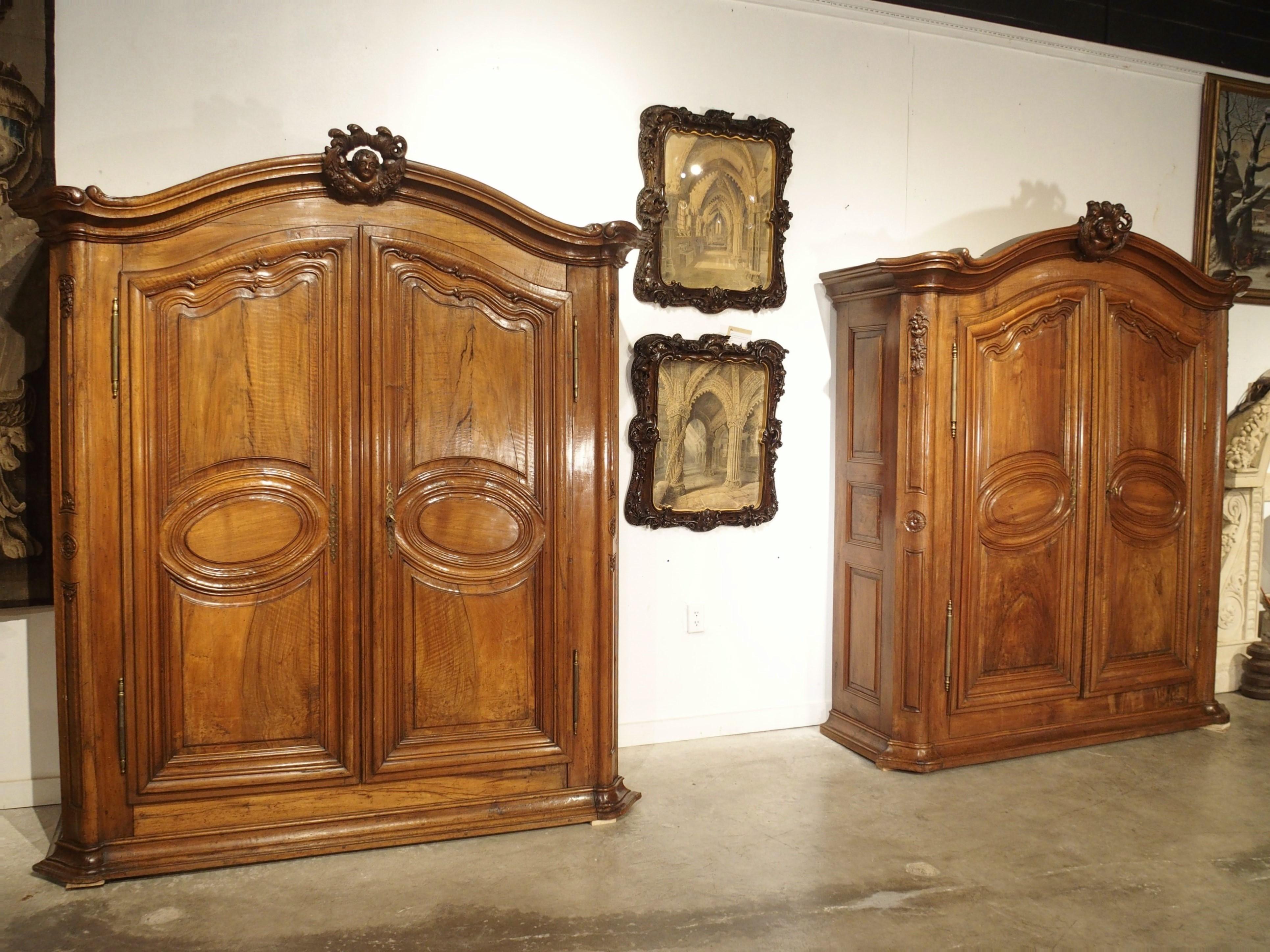 This rare pair of walnut and olive wood armoires is from Eastern France. The armoires were specially commissioned in the early 1700’s and at one point were property of a chocoladefabriek (chocolate factory) in Strasbourg, located in the region of