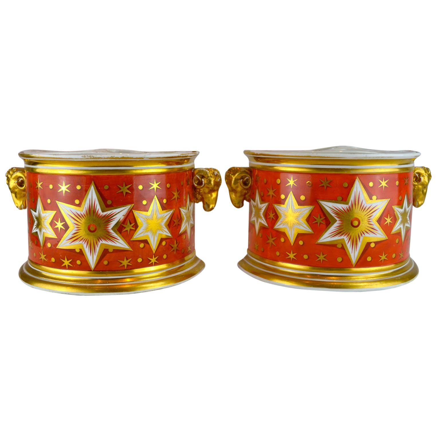 Pair of English early 19th century Worcester demmi=lune bough pots feraturing a rare orange ground with central band of gilded six pointed stars on a white ground. 

The painting and gilding of the Chamberlains Worcester factory met the highest